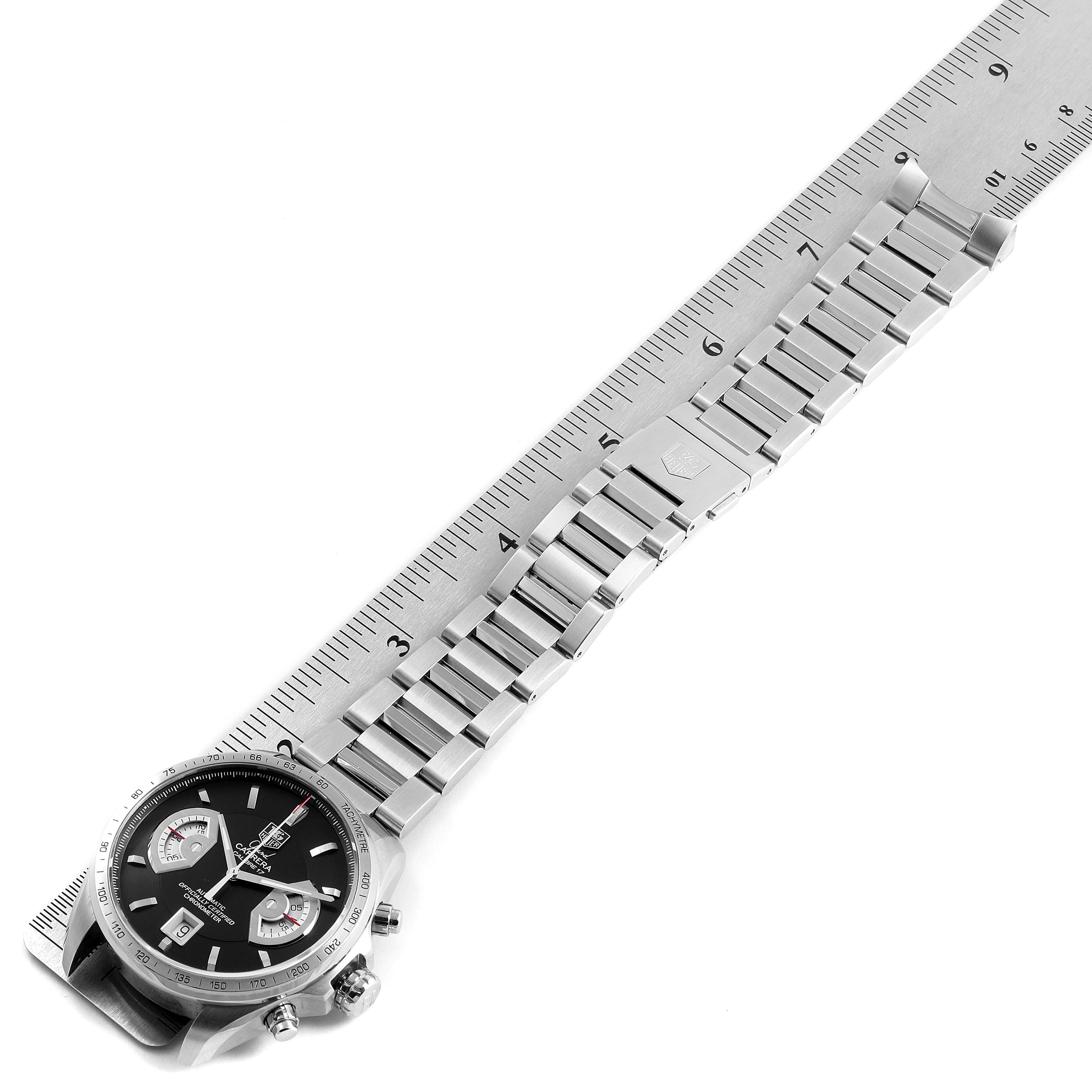 The image shows a Tag Heuer Carrera CAV511A Men's Stainless Steel Black Dial CAV511A Men's Stainless Steel Black Dial watch laid flat with its metal strap extended and measured against a ruler.