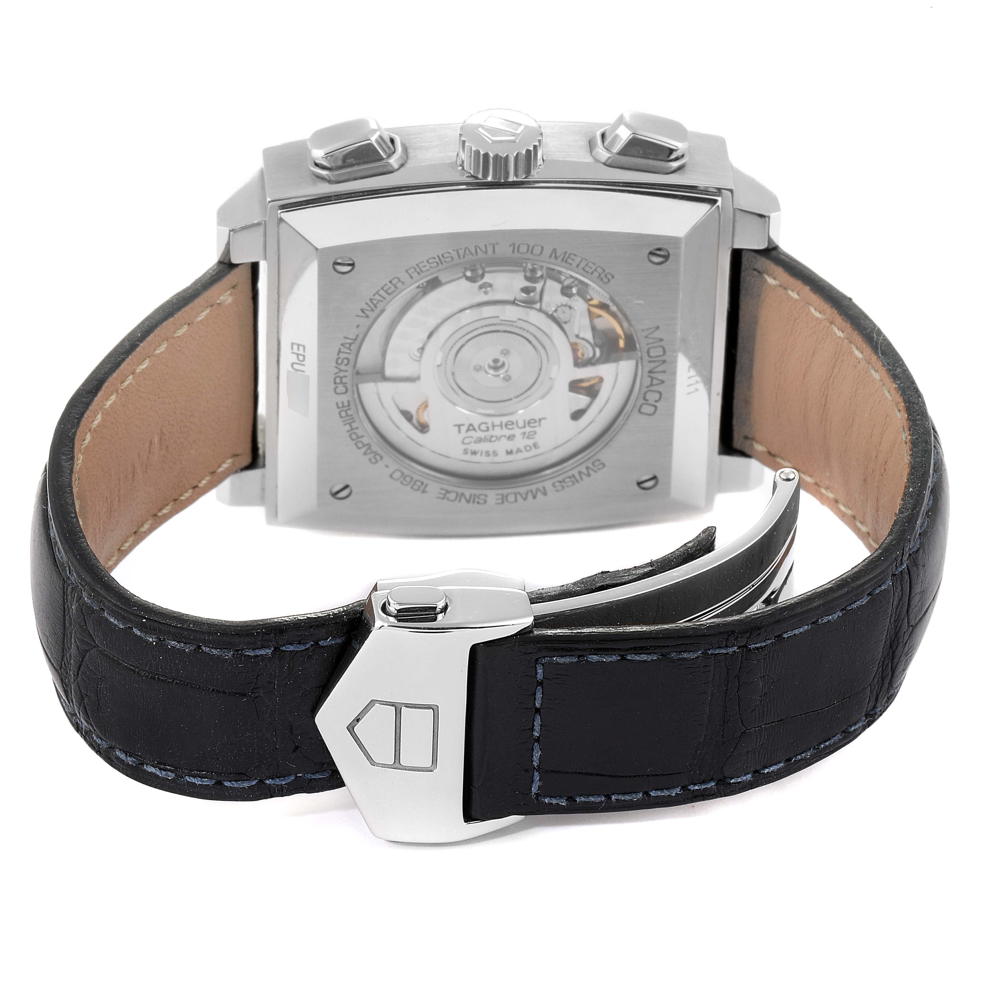 The image shows the back of a Tag Heuer Monaco CAW2111 Men's Stainless Steel Blue Dial CAW2111 Men's Stainless Steel Blue Dial watch, highlighting its movement and clasp.