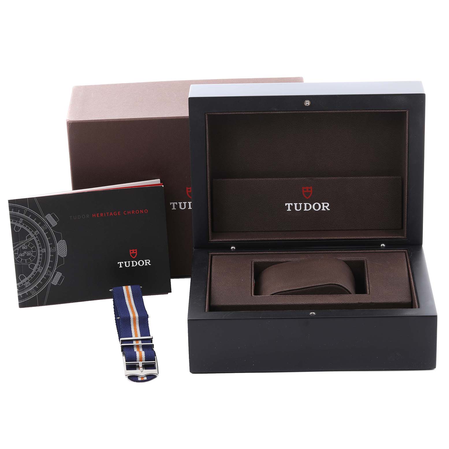 The image shows an empty watch box, a booklet, and a strap for the Tudor Heritage Chrono 70330 Men's Stainless Steel Blue Dial 70330 Men's Stainless Steel Blue Dial.