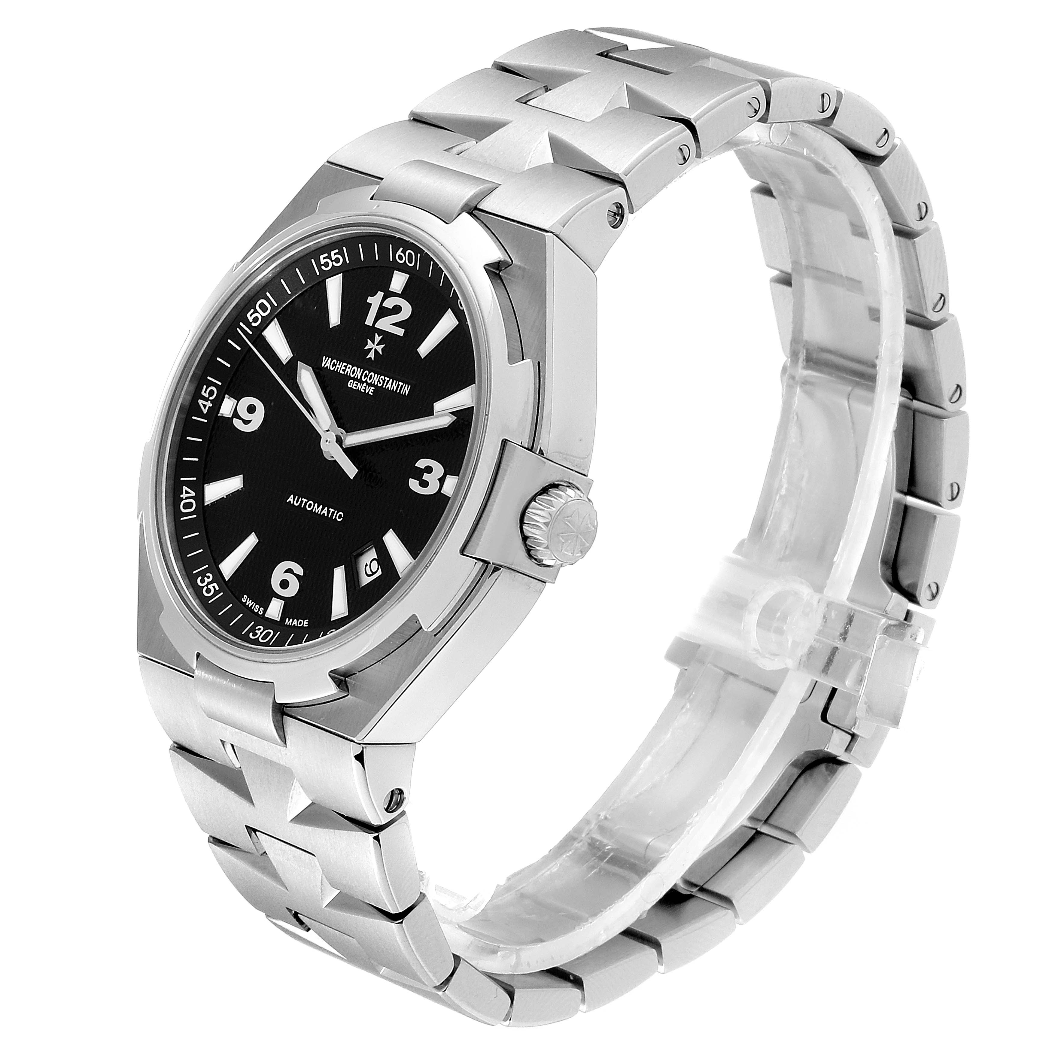 The Vacheron Constantin Overseas 47040/B01A-9094 Men's Stainless Steel Black Dial 47040/B01A-9094 Men's Stainless Steel Black Dial watch is shown at a three-quarter angle, displaying the dial, bezel, crown, and stainless steel bracelet.