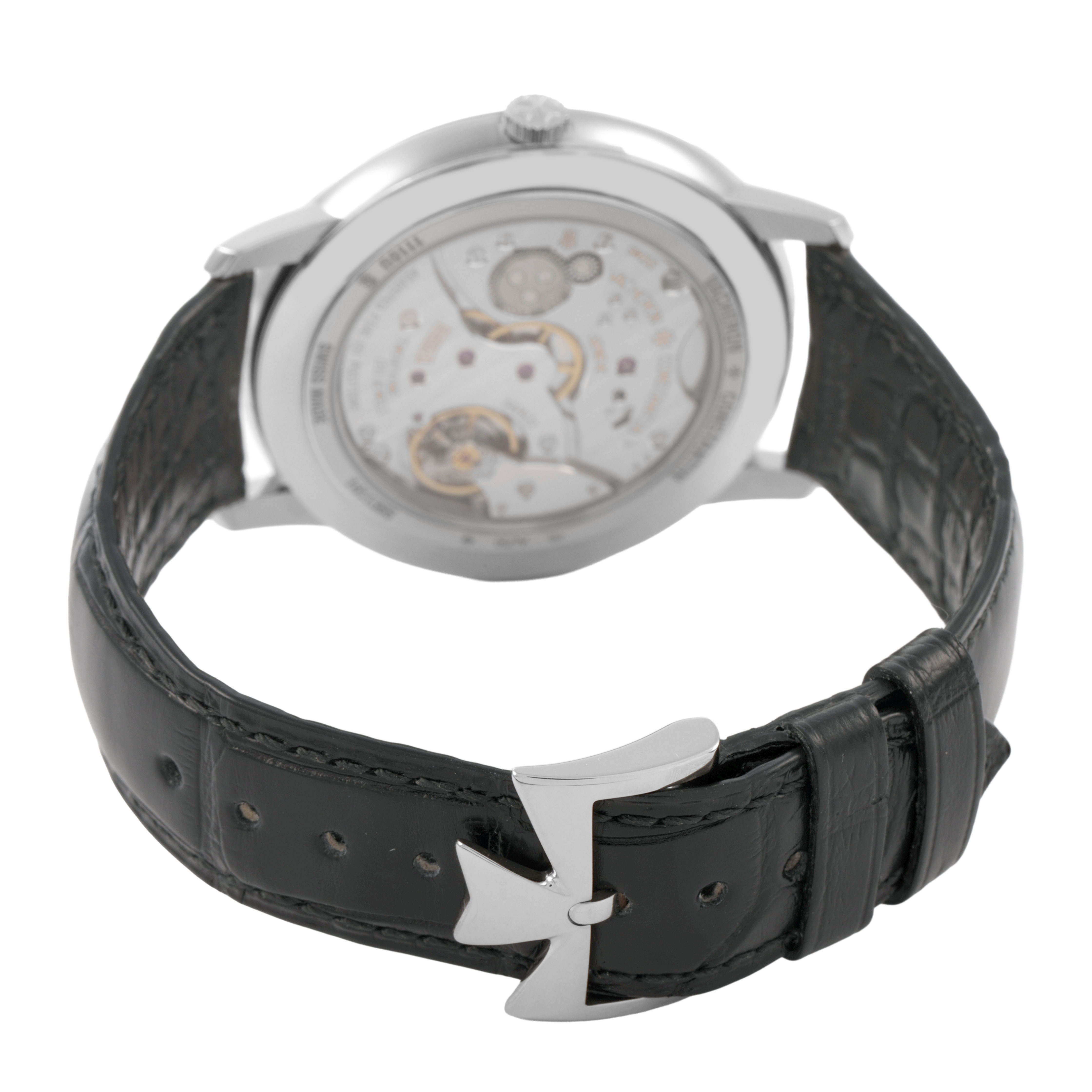 The image shows a Vacheron Constantin Patrimony 1110U/000G-B086 Men's White Gold Silver Dial watch from a rear angle, displaying the movement and black leather strap with clasp.