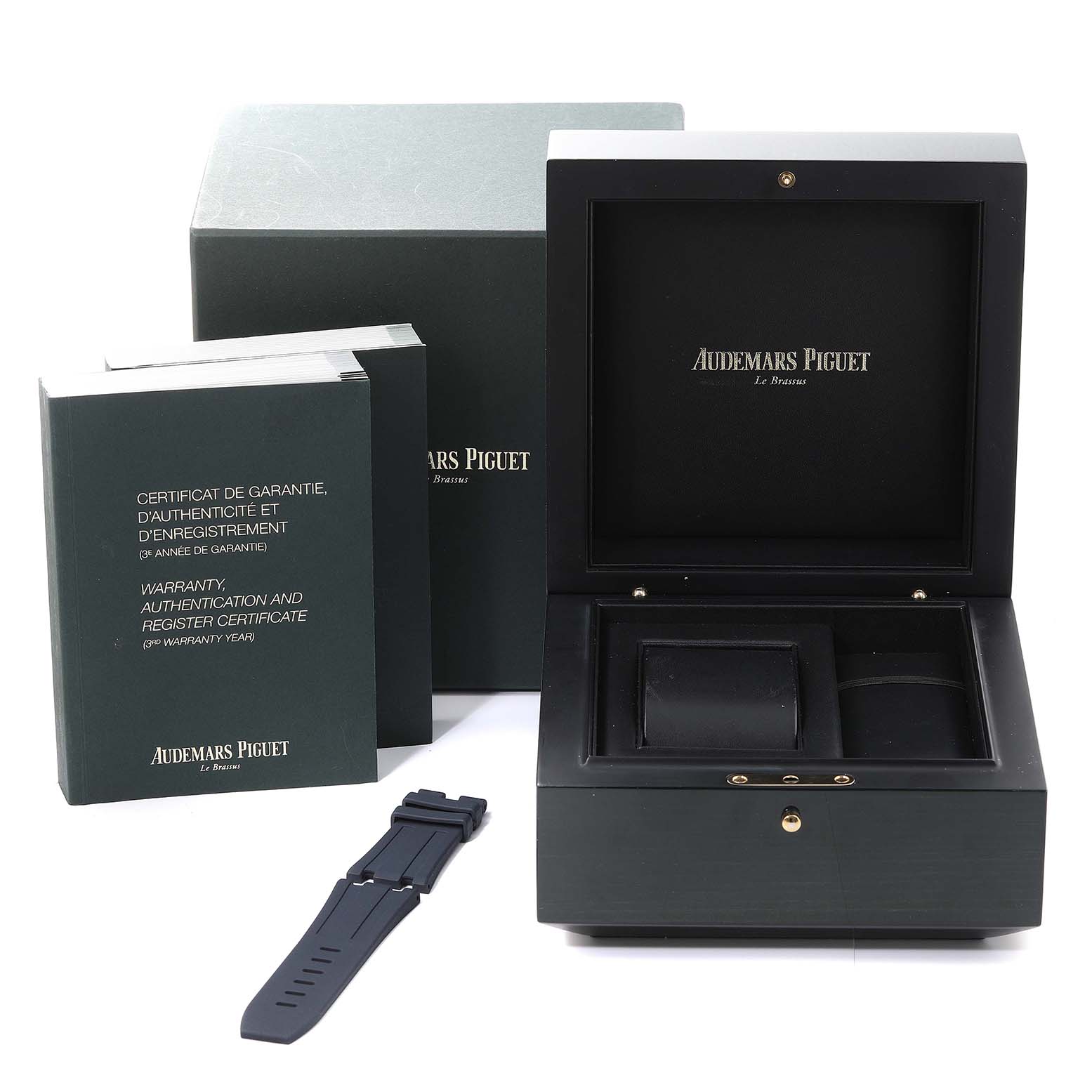 This image shows a storage box, a wrist strap, and warranty booklets for an Audemars Piguet Royal Oak Offshore 15710ST.00.A002CA.02 Men's Stainless Steel White Dial 15710ST.00.A002CA.02 Men's Stainless Steel White Dial watch.
