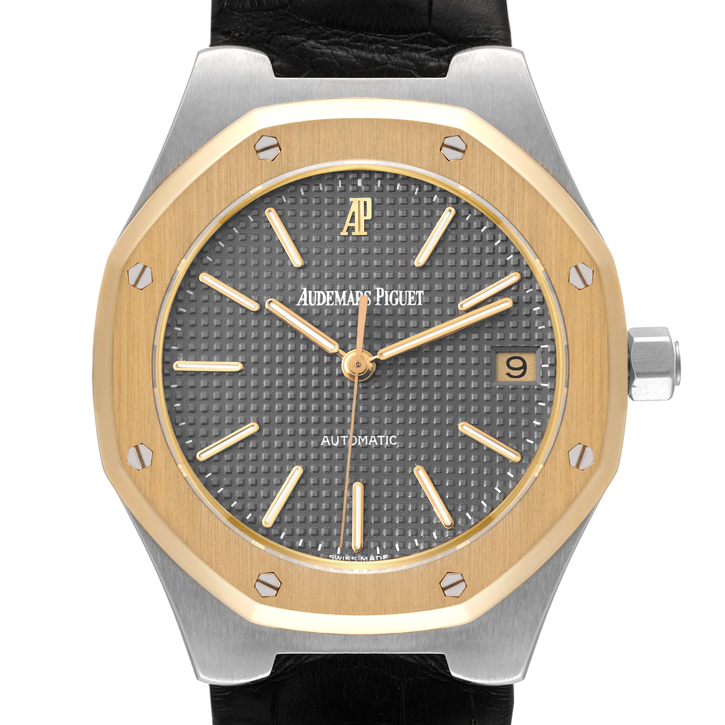 The image shows a frontal view of the Audemars Piguet Royal Oak Men
s Steel and Gold (two tone) Grey Dial Men
s Steel and Gold (two tone) Grey Dial watch, featuring its octagonal bezel, grey textured dial, and date window.