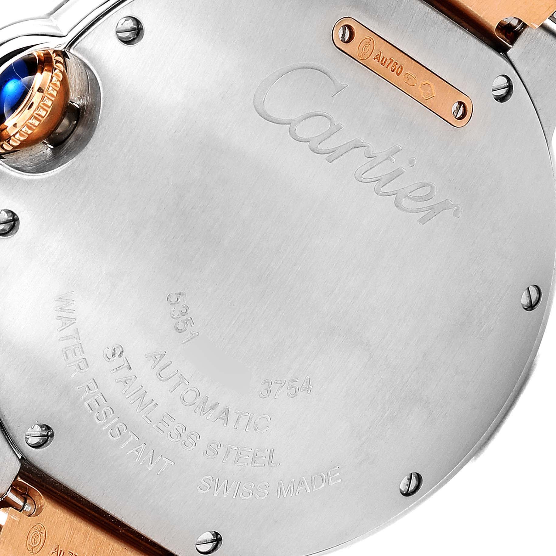 This image shows the back case of a Cartier Ballon Bleu W2BB0003 Women
s Steel and Gold (two tone) Silver Dial W2BB0003 Women
s Steel and Gold (two tone) Silver Dial watch, highlighting the inscription and blue cabochon crown.