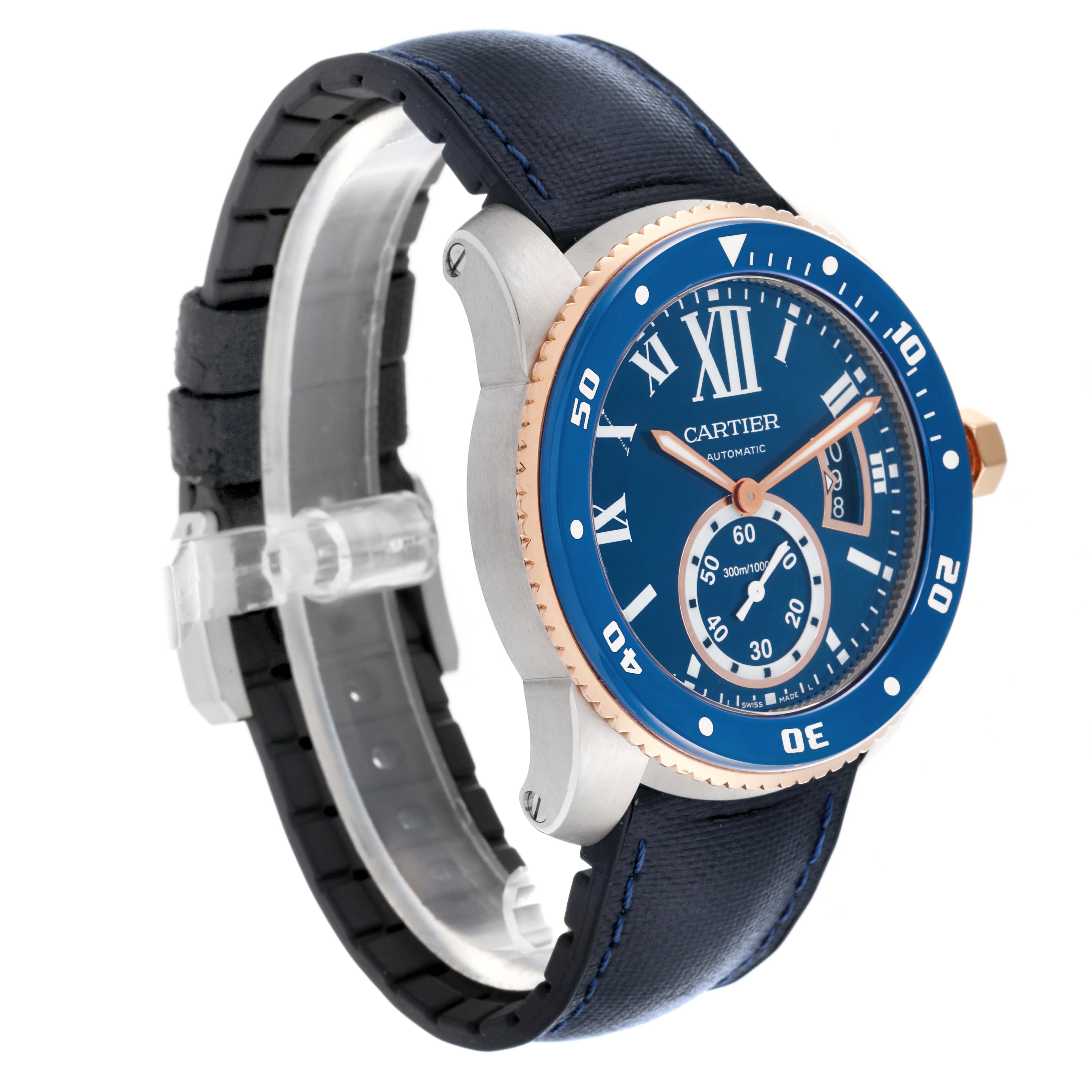 The Calibre de Cartier watch is shown at a three-quarter angle, displaying its blue face, bezel, and leather band.