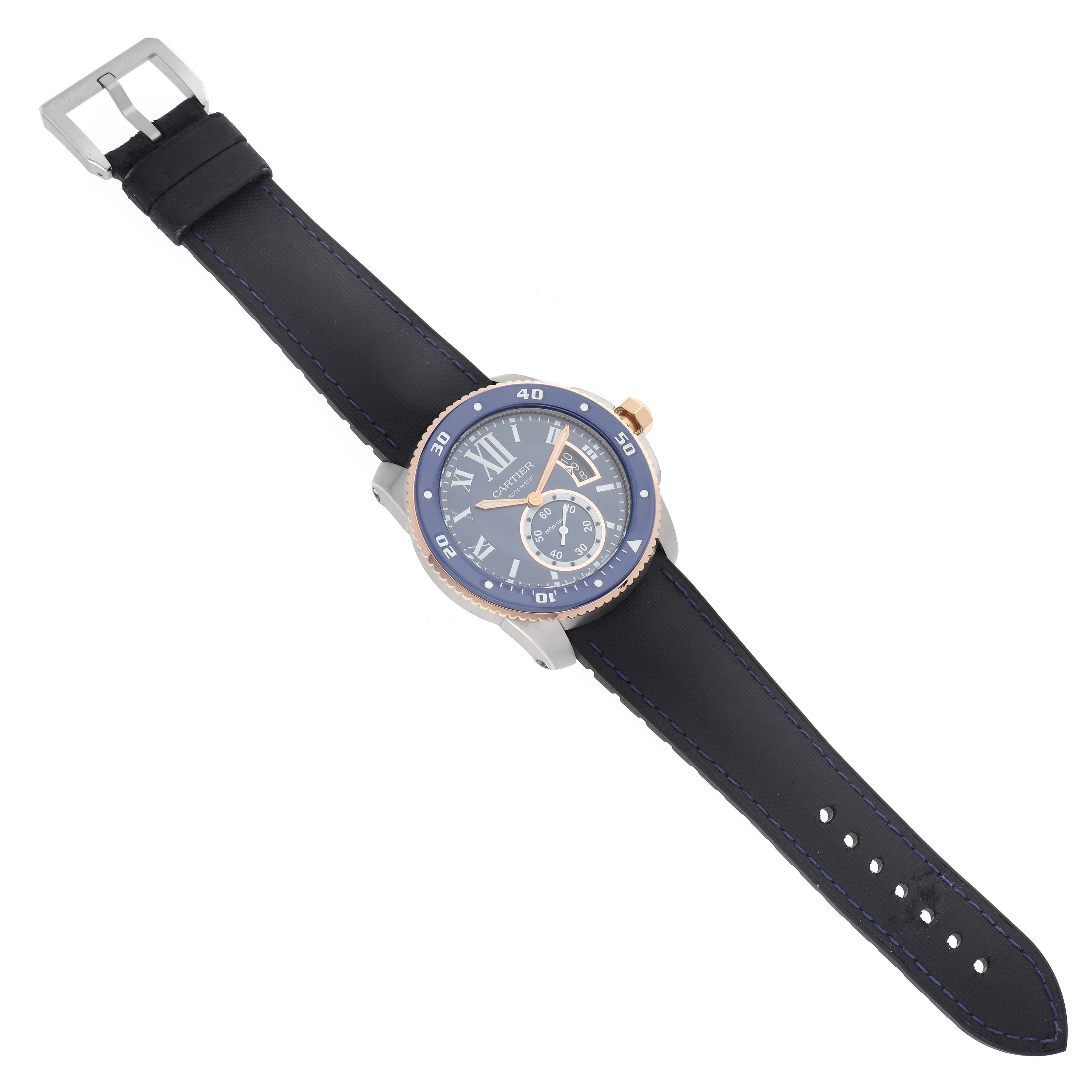 The Calibre de Cartier watch is shown at an angle displaying the face, bezel, crown, and full strap.