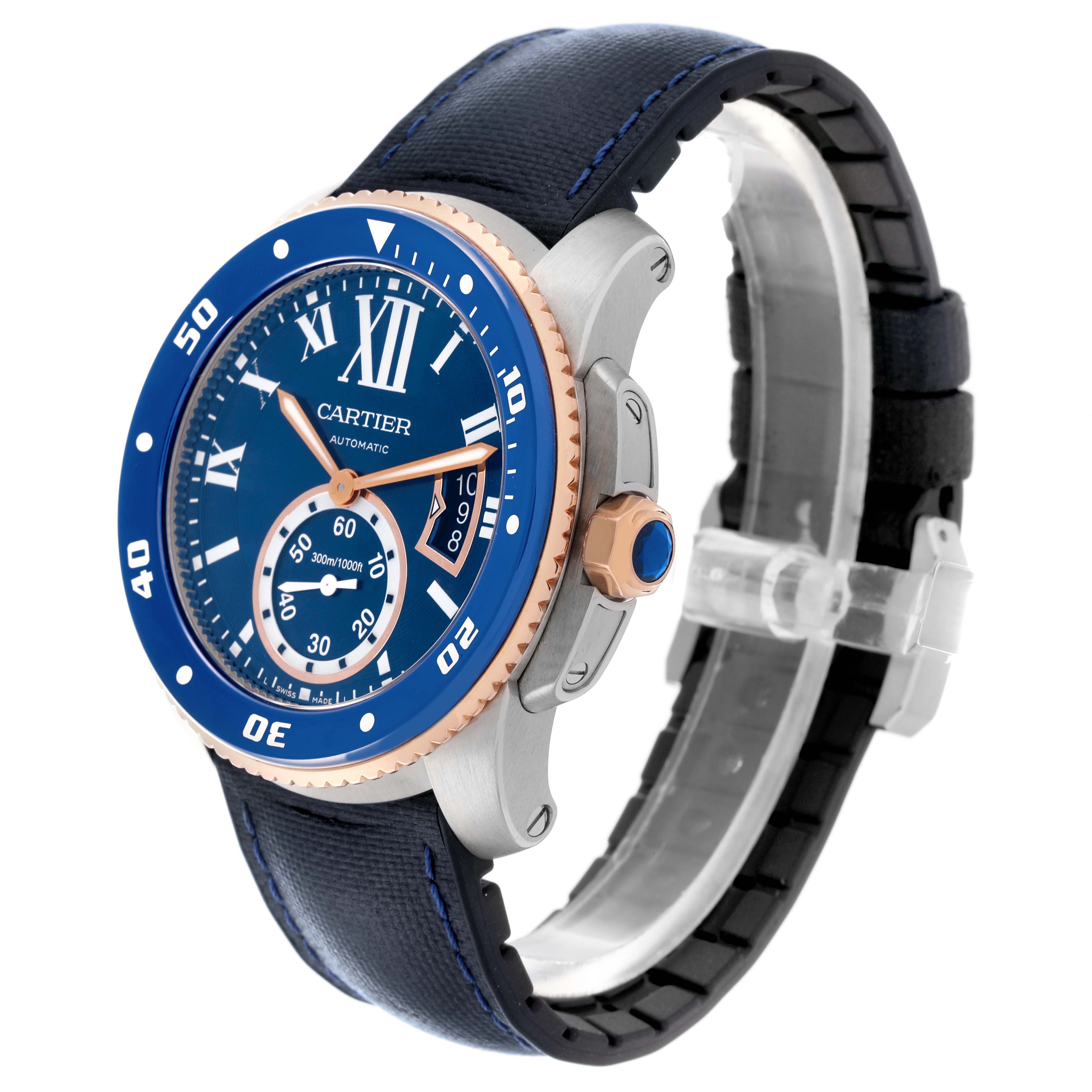 The Calibre de Cartier watch is shown at a three-quarter angle, displaying its blue dial, bezel, and leather strap.