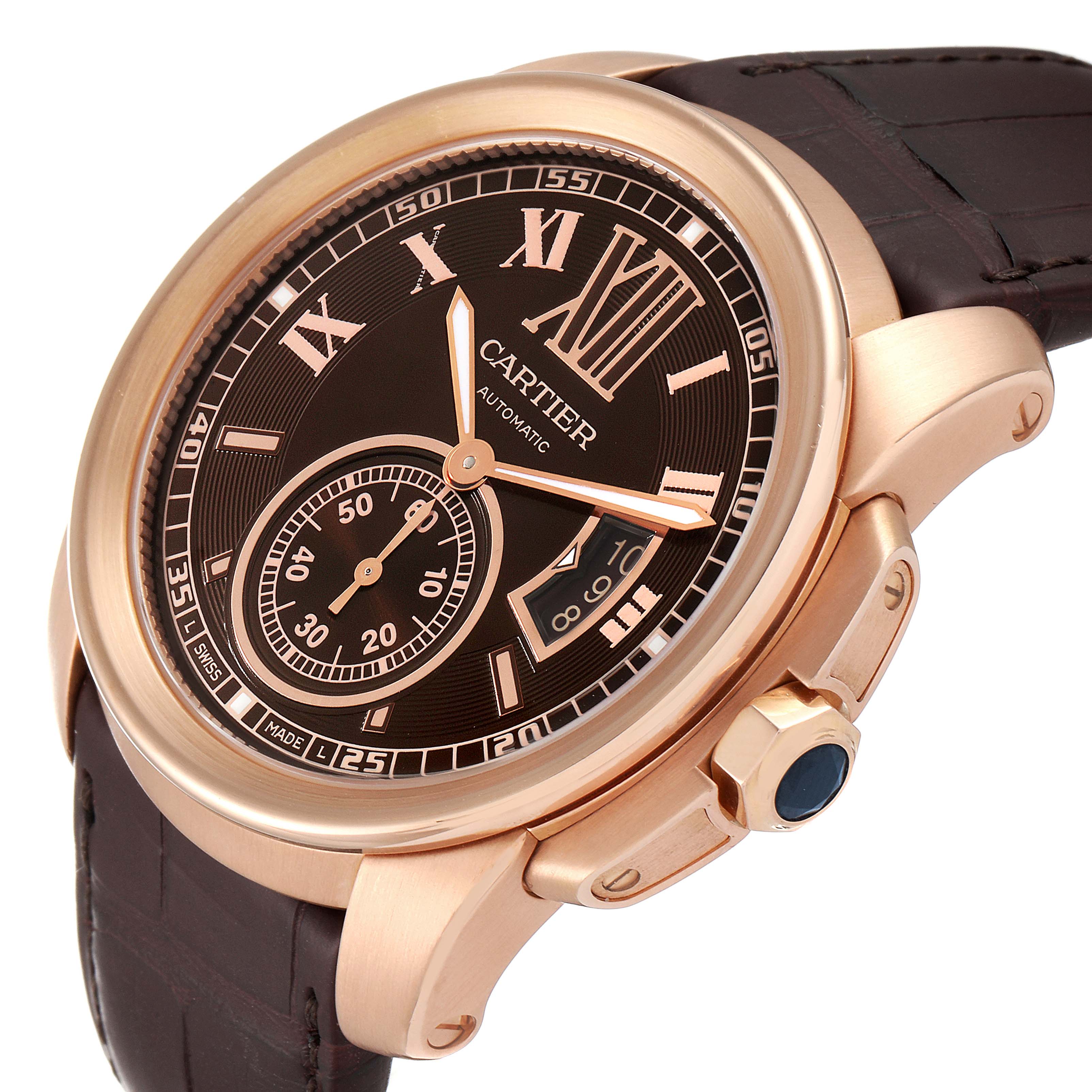 This image shows a close-up angle of a Calibre de Cartier watch by Cartier, featuring the bezel, dial, crown, and strap.