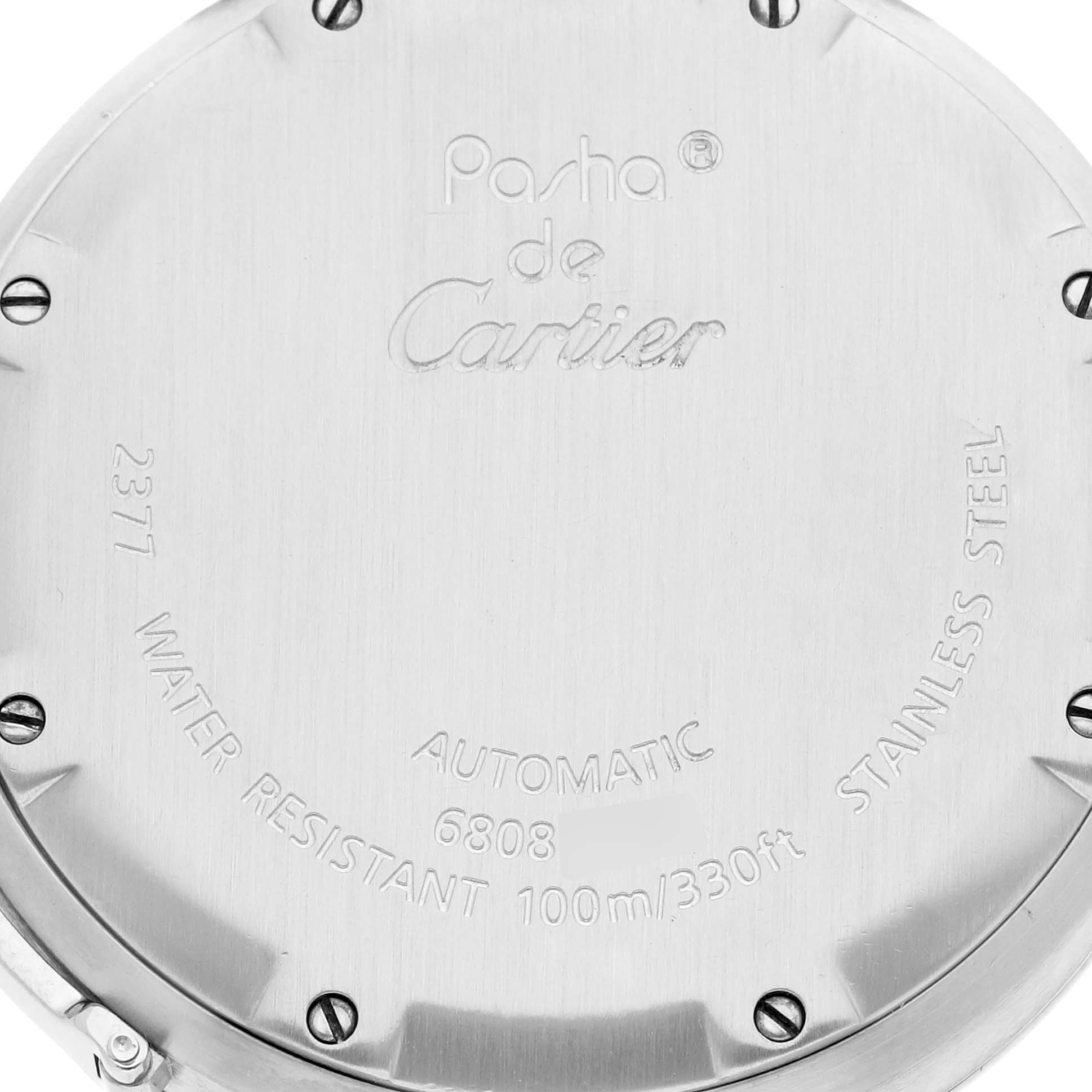The image shows the back case of a Cartier Pasha W31078M7 Men's Stainless Steel Silver Dial W31078M7 Men's Stainless Steel Silver Dial watch, displaying engravings and screws.