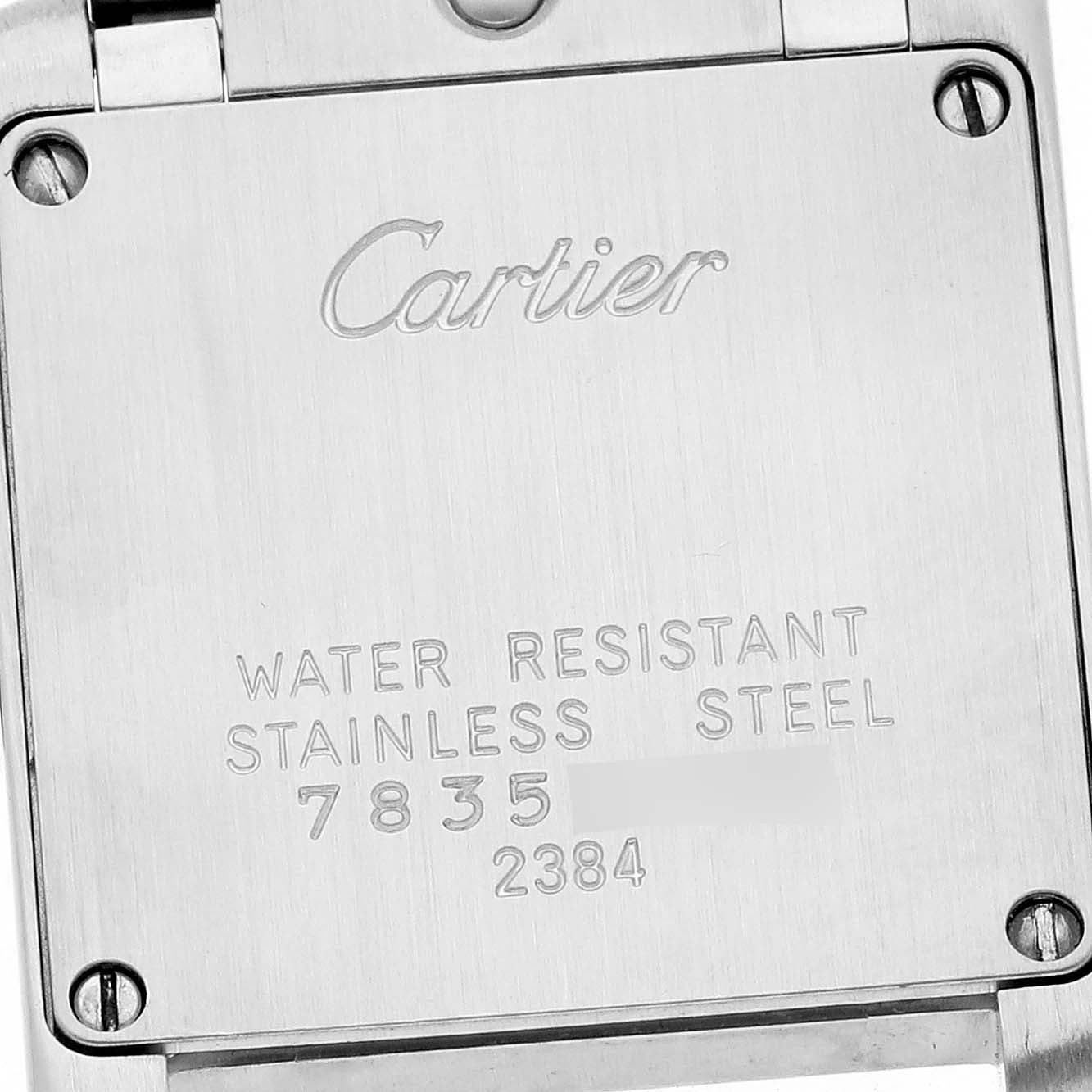 The image shows the back case of the Cartier Tank Française watch, highlighting its engraving and screws.