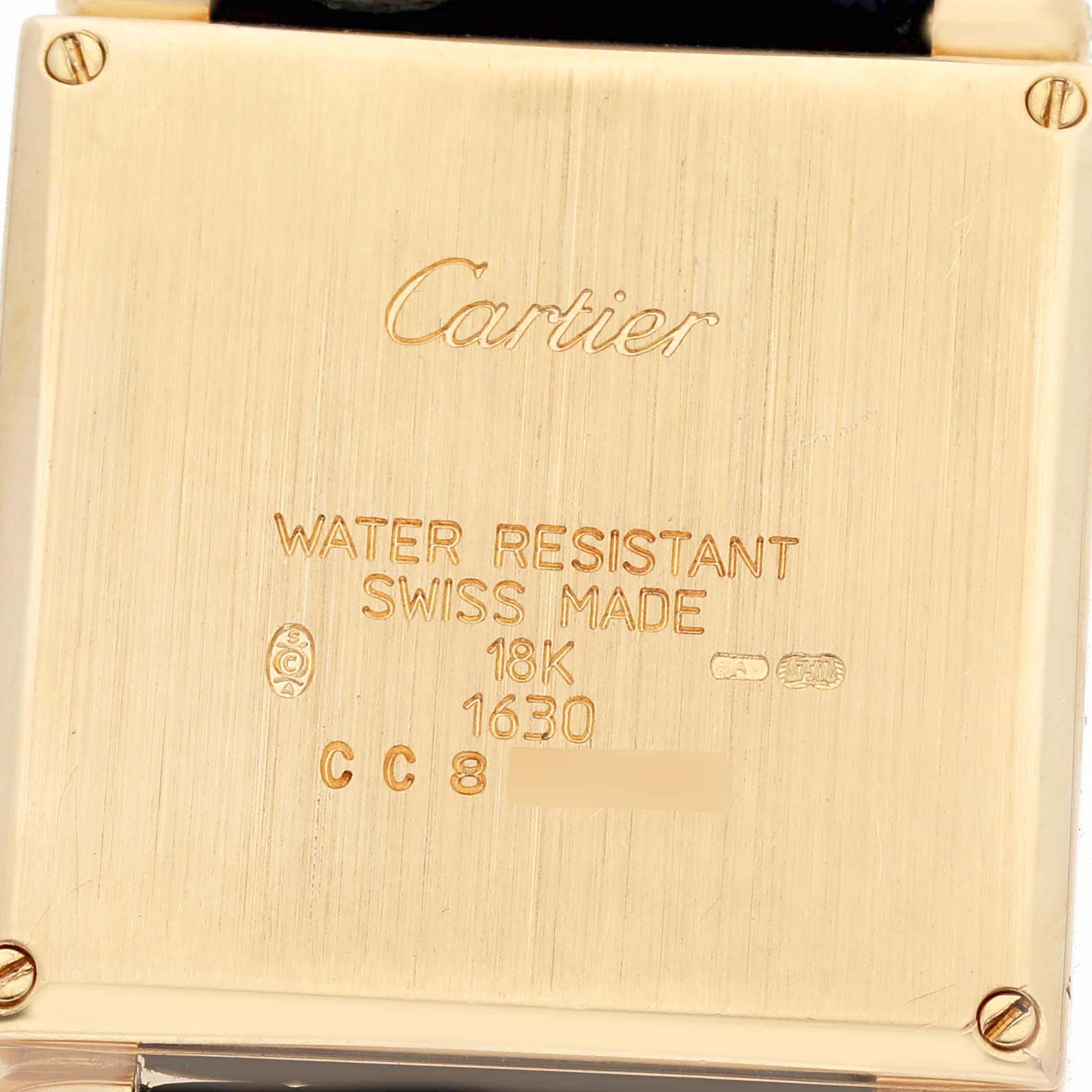 The image shows the back of a Cartier Tank Obus W1532756 Women's Yellow Gold Silver Dial W1532756 Women's Yellow Gold Silver Dial watch case, highlighting engravings and screws.