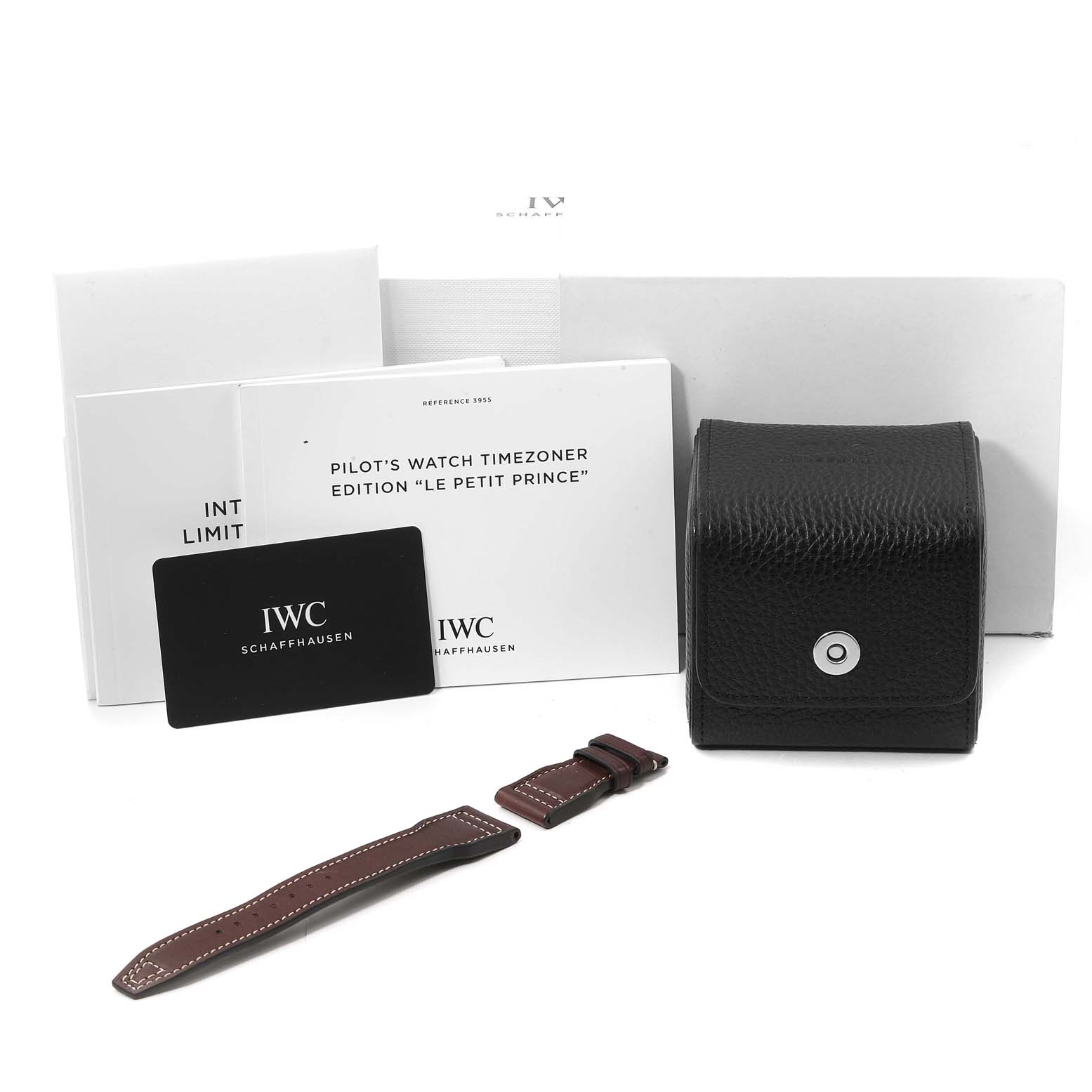 This image shows the packaging, documentation, watch strap, and case for an IWC Pilot IW395503 Men's Stainless Steel Blue Dial IW395503 Men's Stainless Steel Blue Dial's Watch Timezoner Edition “Le Petit Prince.”