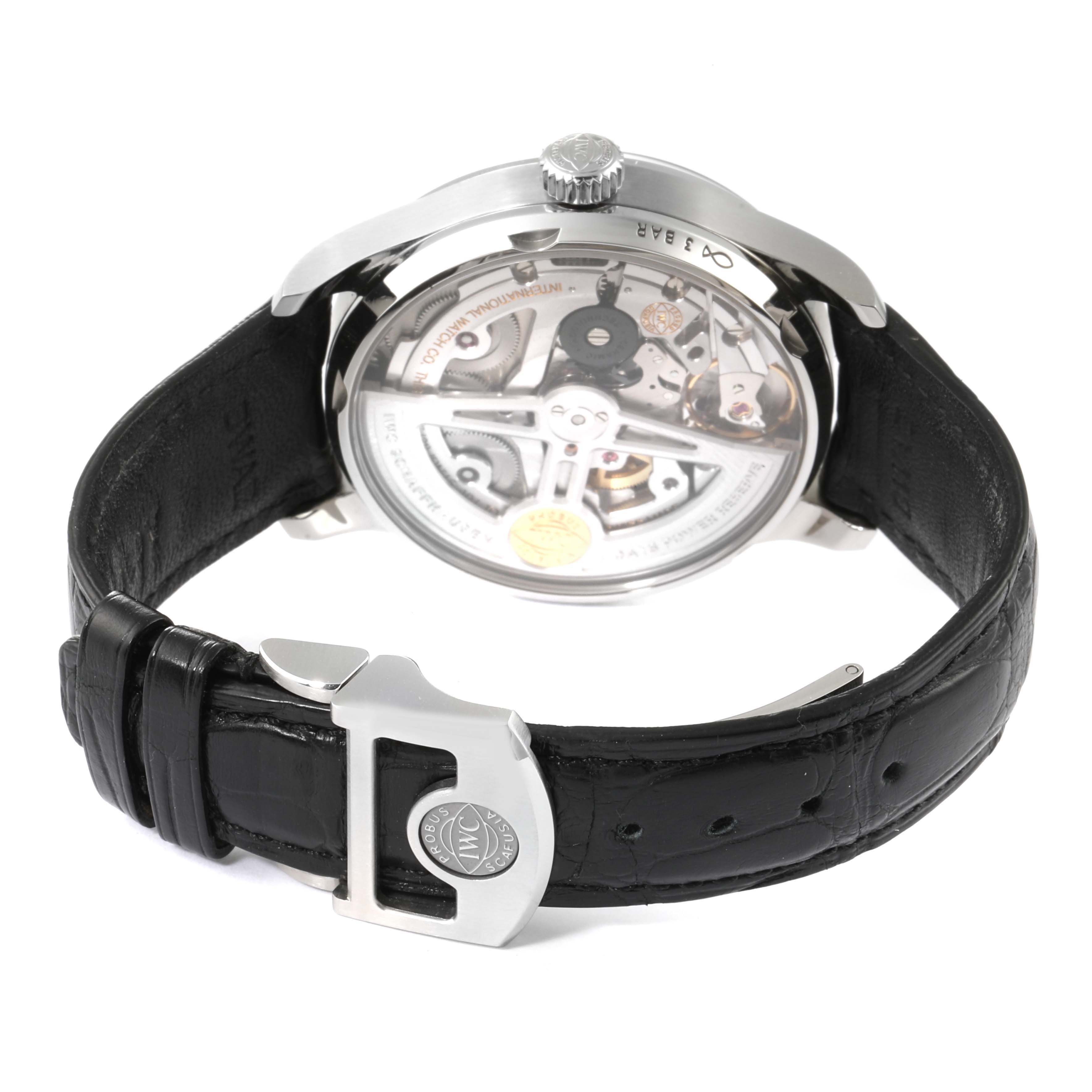 The image shows the rear view of an IWC Portuguese IW500703 Men's Stainless Steel Black Dial IW500703 Men's Stainless Steel Black Dial watch, highlighting its internal mechanism and leather strap.