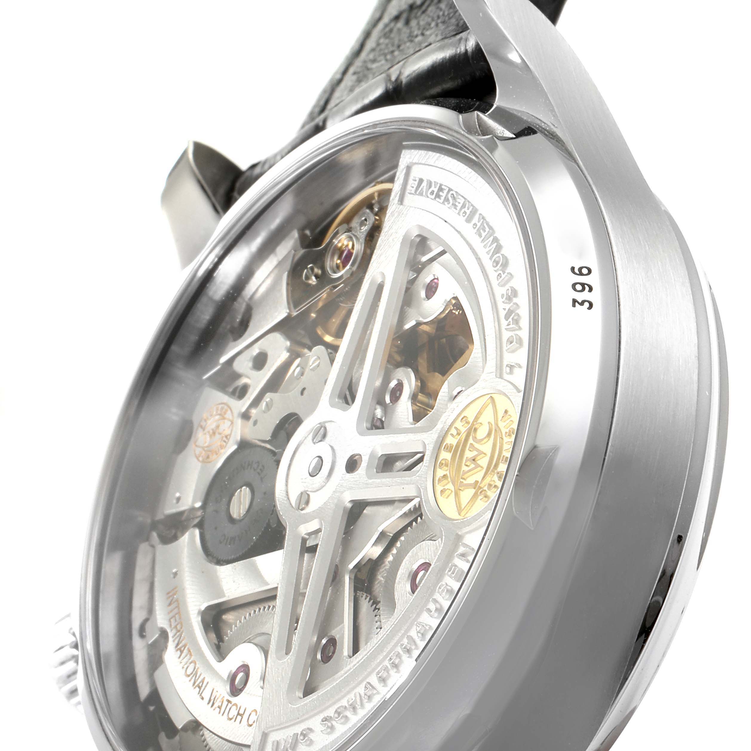 The image shows the back view of an IWC Portuguese IW500703 Men's Stainless Steel Black Dial IW500703 Men's Stainless Steel Black Dial model watch, highlighting its intricate mechanism and rotor.