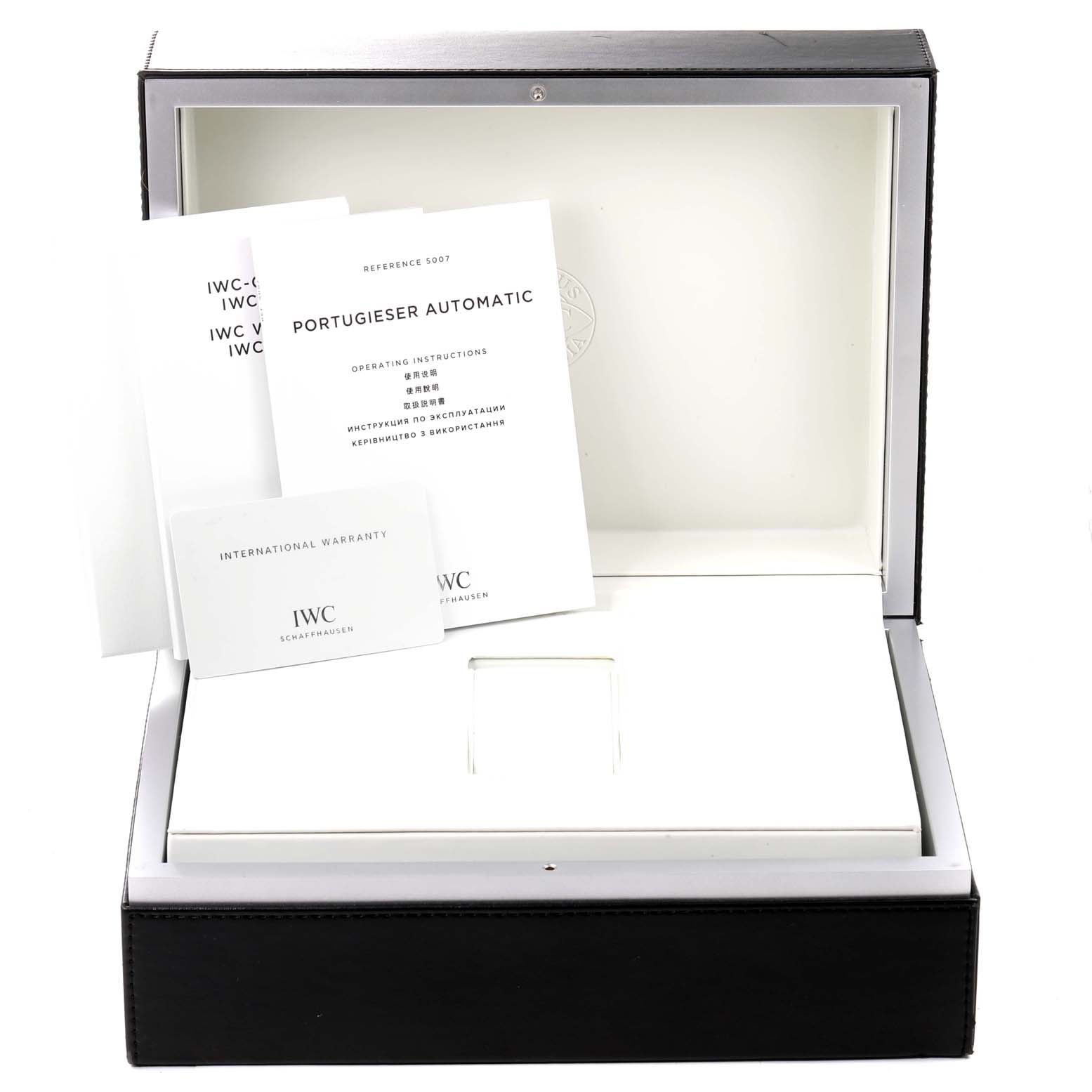 This image shows the packaging and manuals for an IWC Portuguese IW500703 Men's Stainless Steel Black Dial IW500703 Men's Stainless Steel Black Dial model, including the international warranty card and operating instructions.