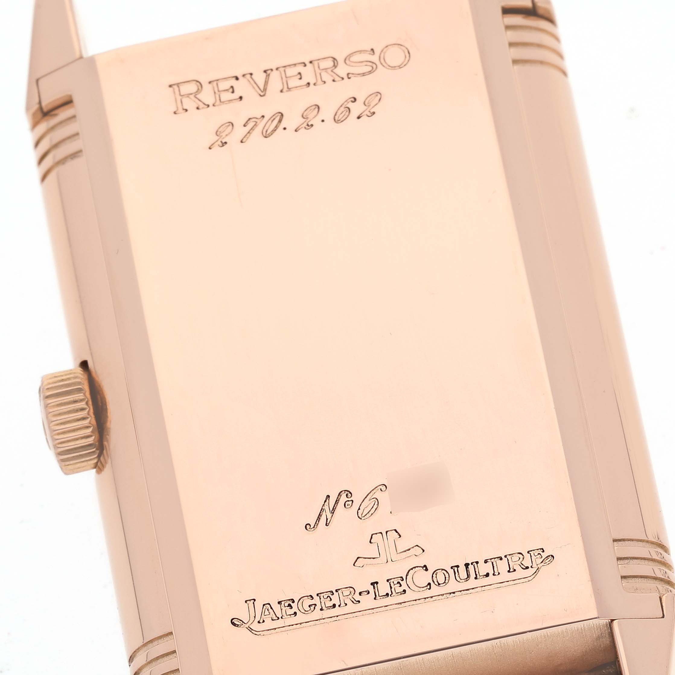 This image shows the engraved reverse side of a Jaeger-LeCoultre Reverso watch, including the model number and crown.