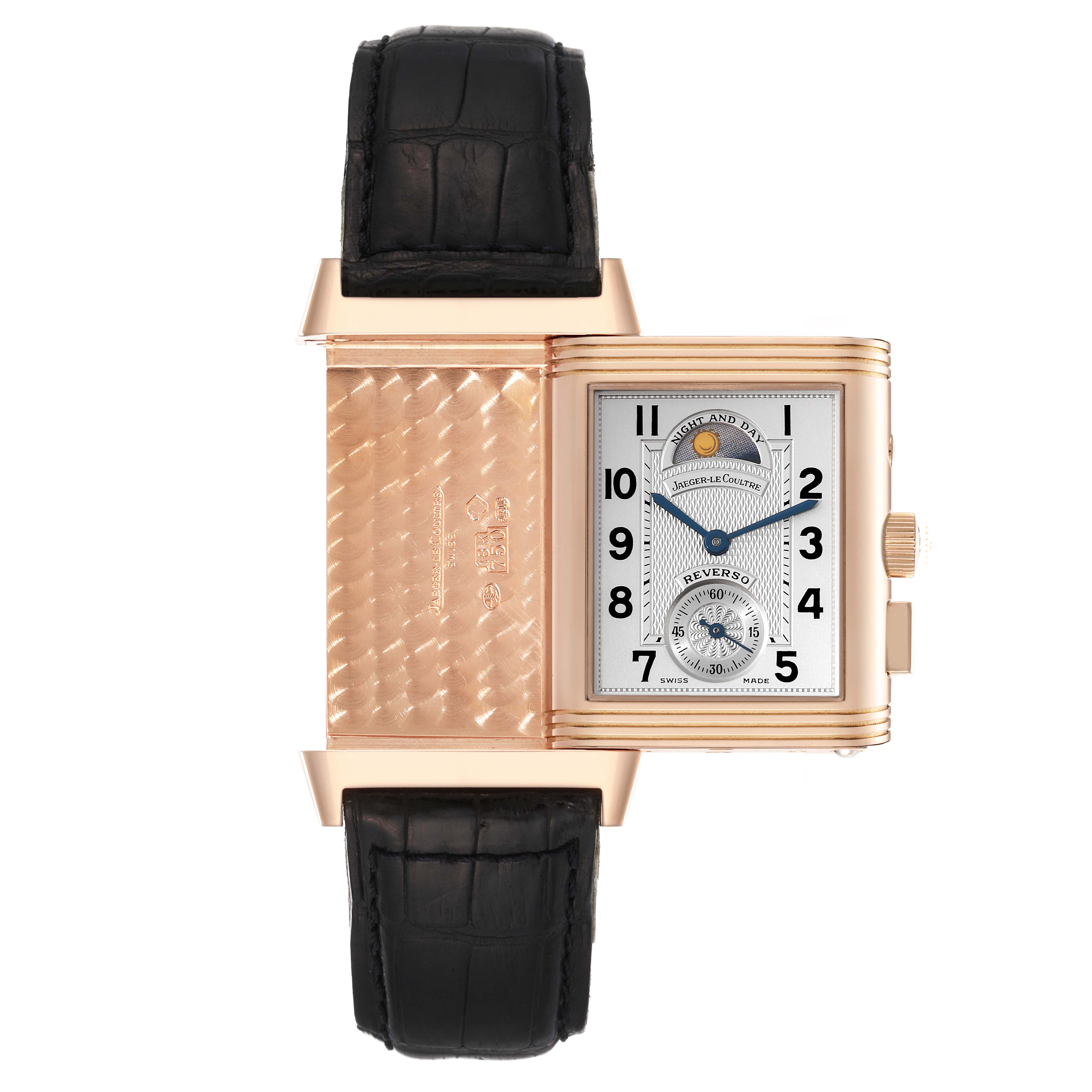 The image shows the Jaeger-LeCoultre Reverso watch at a top-down angle, revealing the reversible case and black strap.