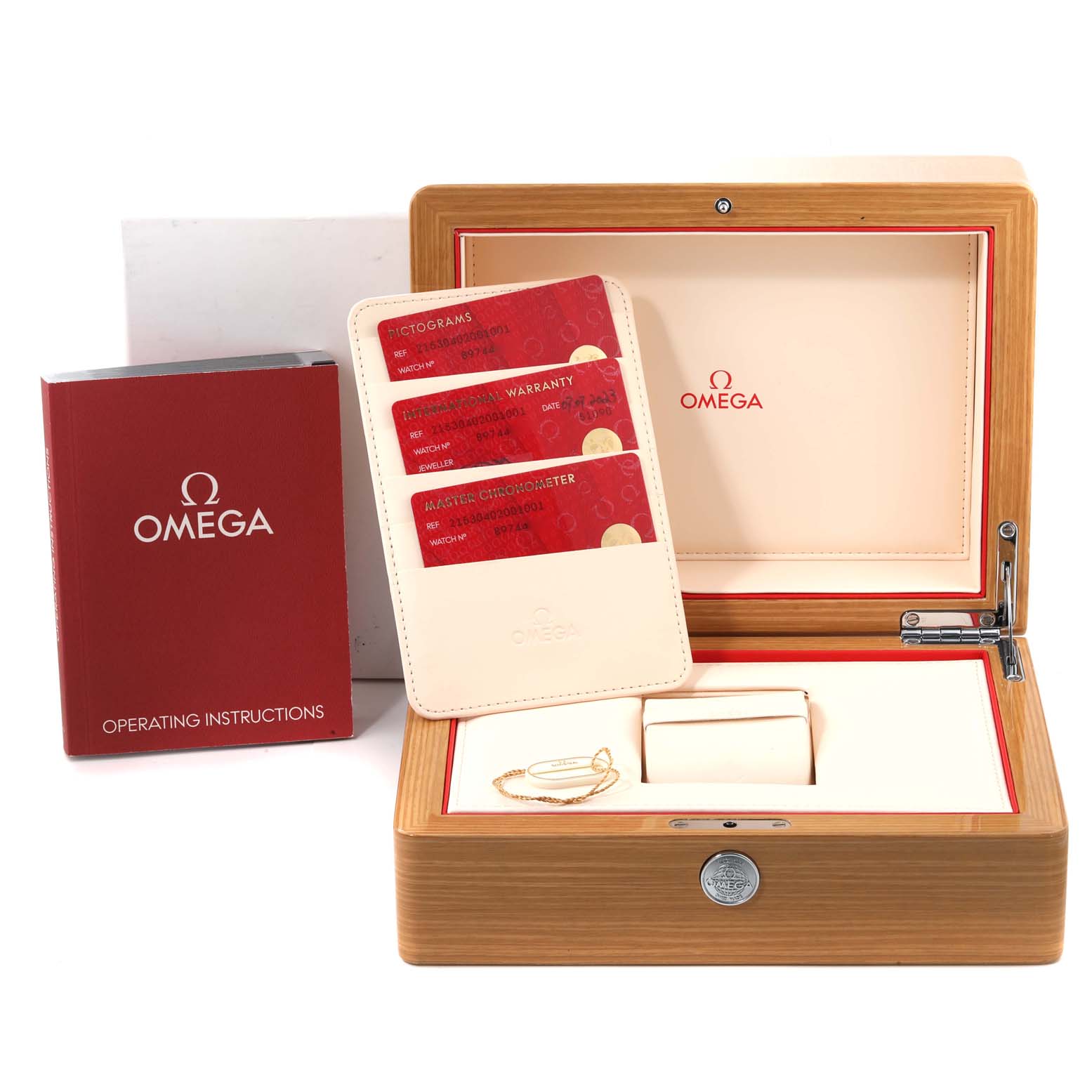 The image shows the packaging and accessories of the Omega Planet Ocean 215.30.40.20.01.001 Men
s Stainless Steel Black Dial 215.30.40.20.01.001 Men
s Stainless Steel Black Dial watch, including the open wooden box, warranty cards, and operating instructions.