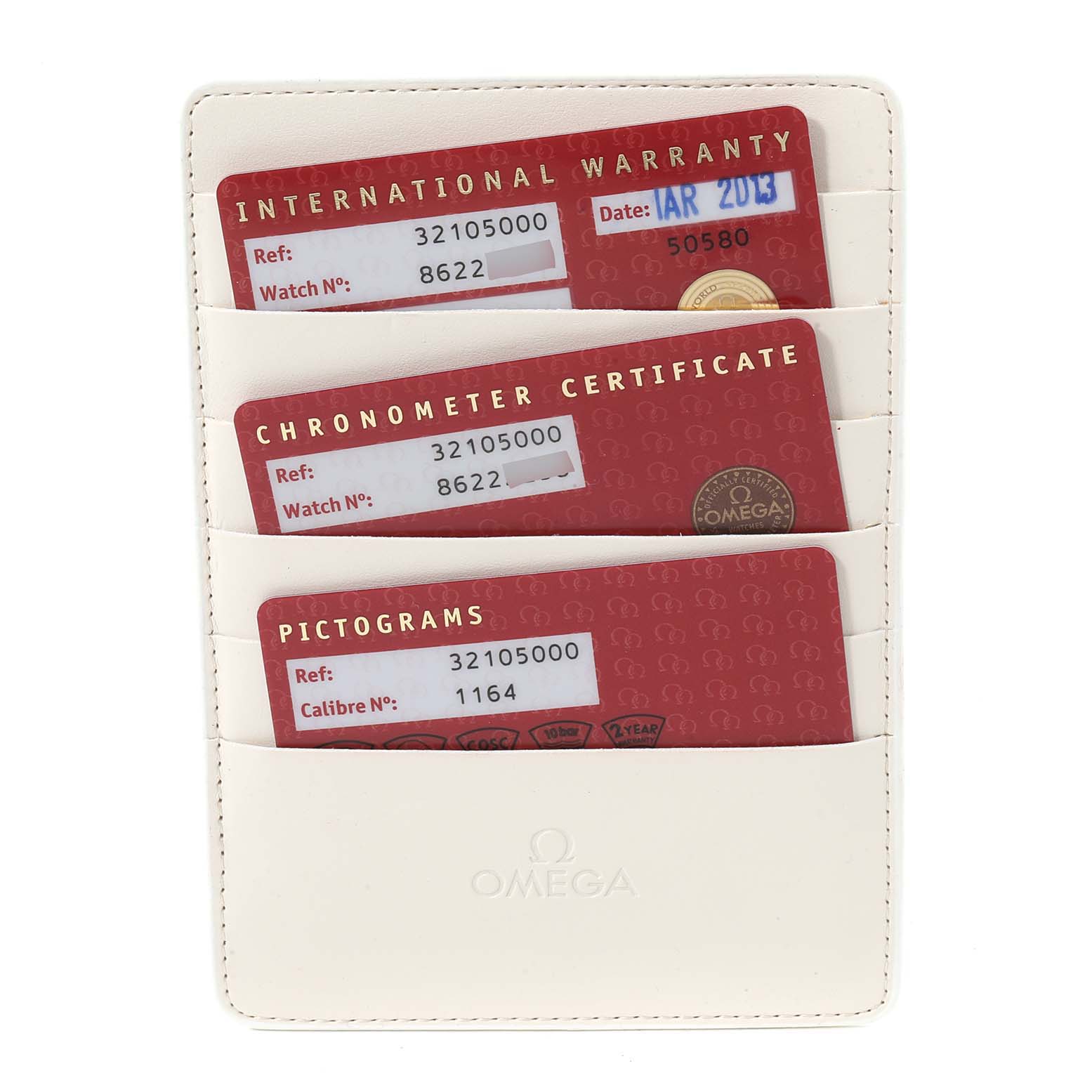 The image shows three red cards—International Warranty, Chronometer Certificate, and Pictograms—in a white card holder for the Omega Speedmaster 3210.50.00 Men
s Stainless Steel Black Dial 3210.50.00 Men
s Stainless Steel Black Dial.