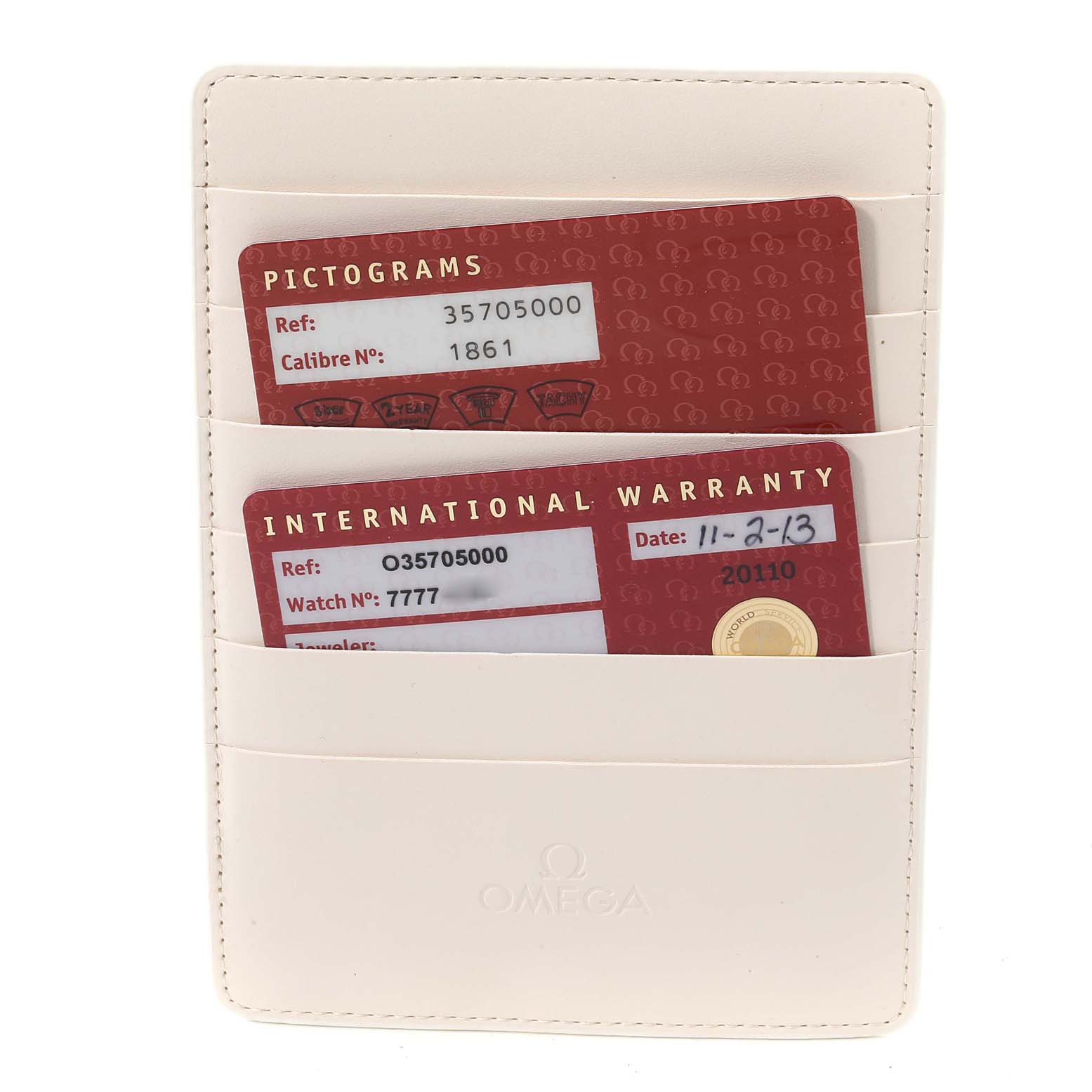 The image shows an Omega Speedmaster 3570.50.00 Men's Stainless Steel Black Dial 3570.50.00 Men's Stainless Steel Black Dial cardholder containing international warranty and pictogram cards.