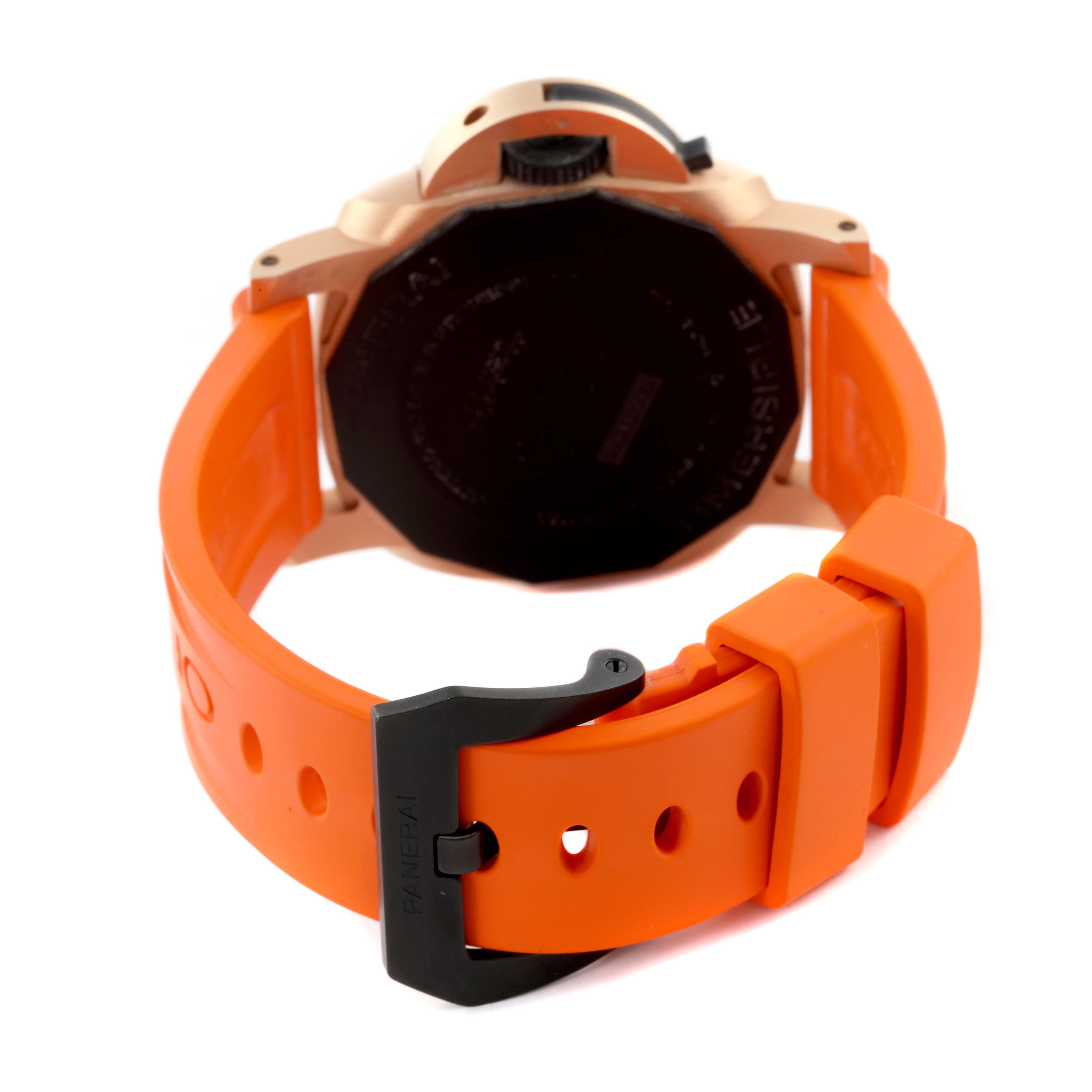 The Panerai Submersible PAM01070 Men's Rose Gold Black Dial PAM01070 Men's Rose Gold Black Dial watch is shown from the back, highlighting the case back, crown, and orange rubber strap with buckle.