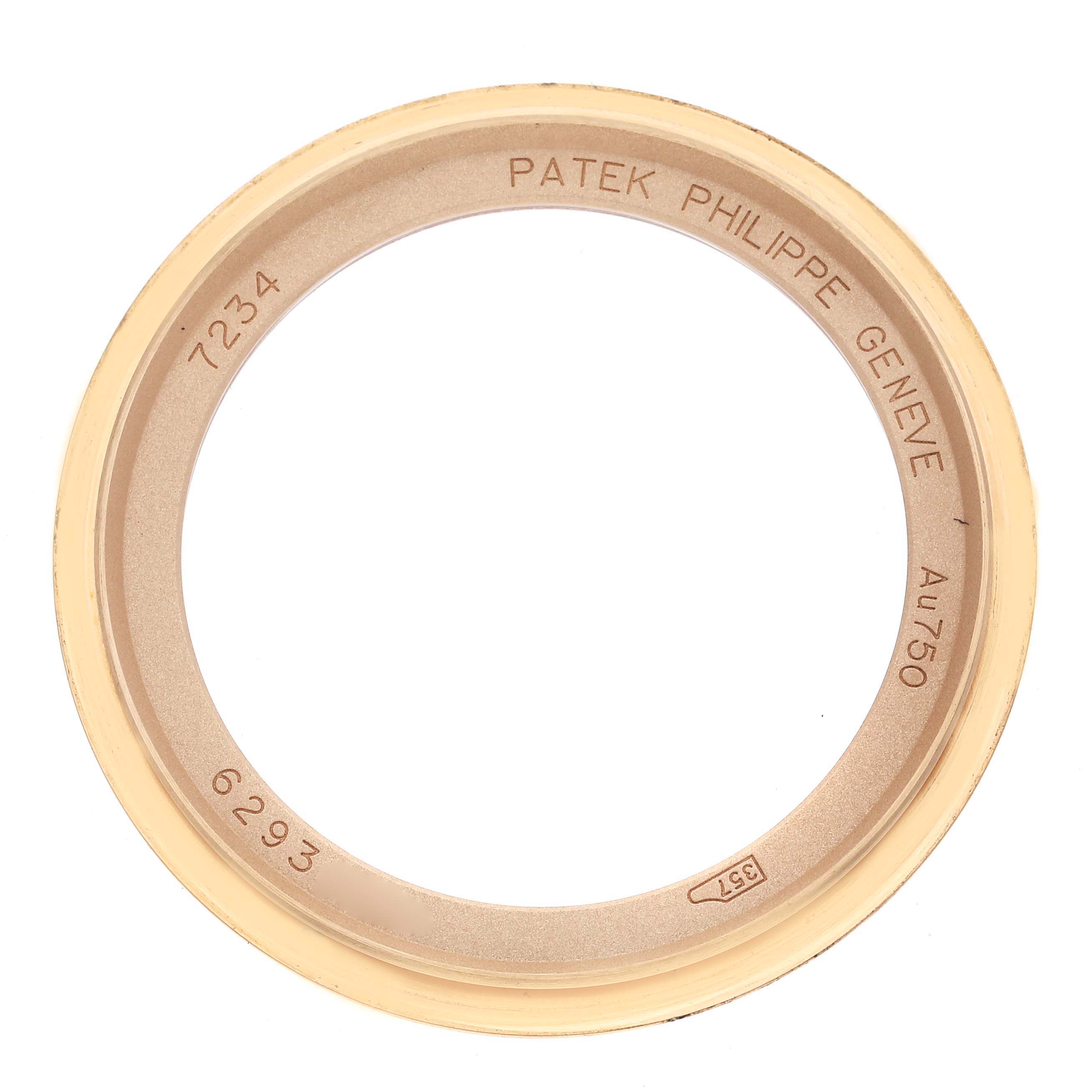 The image shows a top view of a Patek Philippe Calatrava 7234R-001 Men's Rose Gold Brown Dial 7234R-001 Men's Rose Gold Brown Dial watch bezel, displaying engravings and reference numbers.