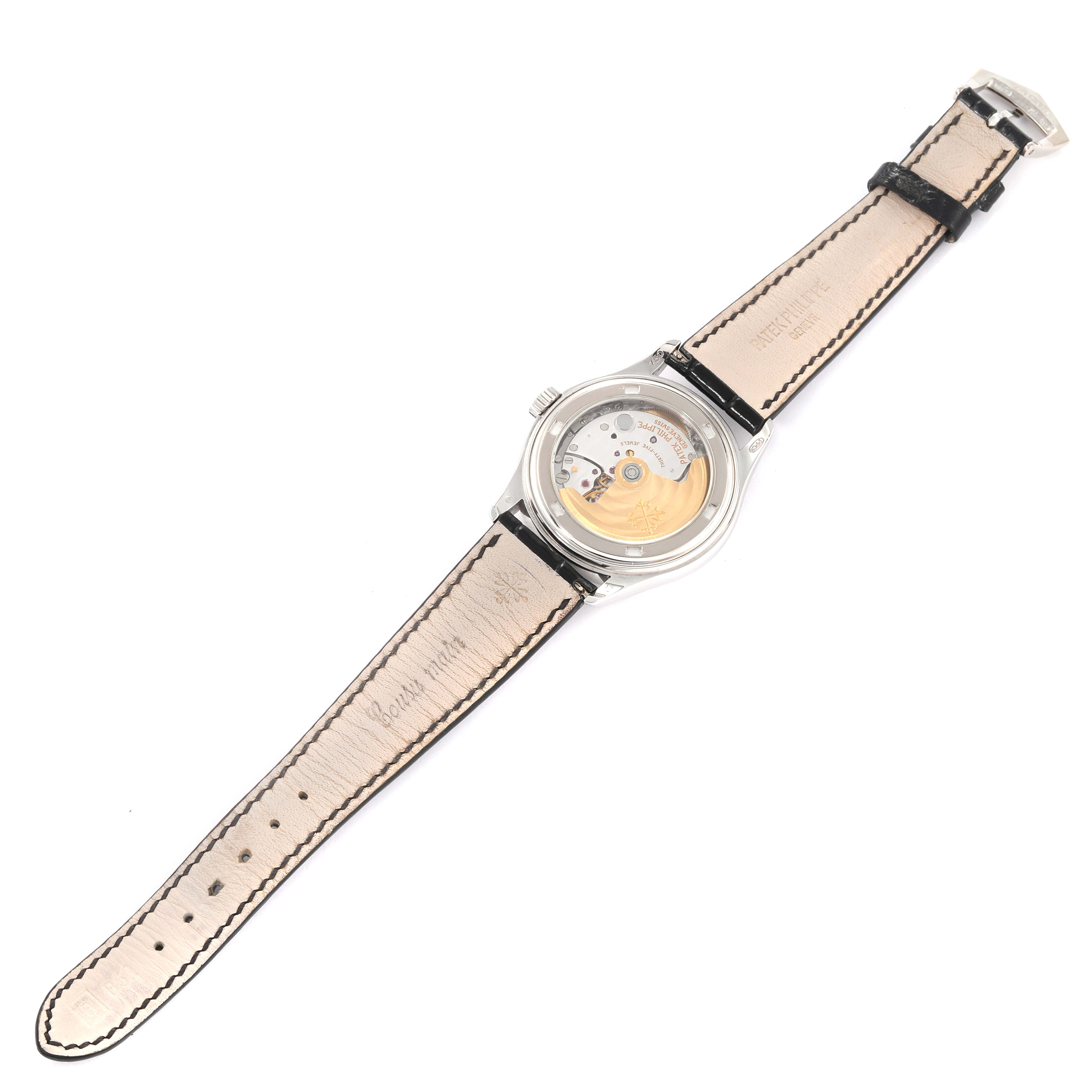 The image shows the back view of a Patek Philippe Complications 5035G Men's White Gold Black Dial 5035G Men's White Gold Black Dial model watch, highlighting its open caseback and movement.