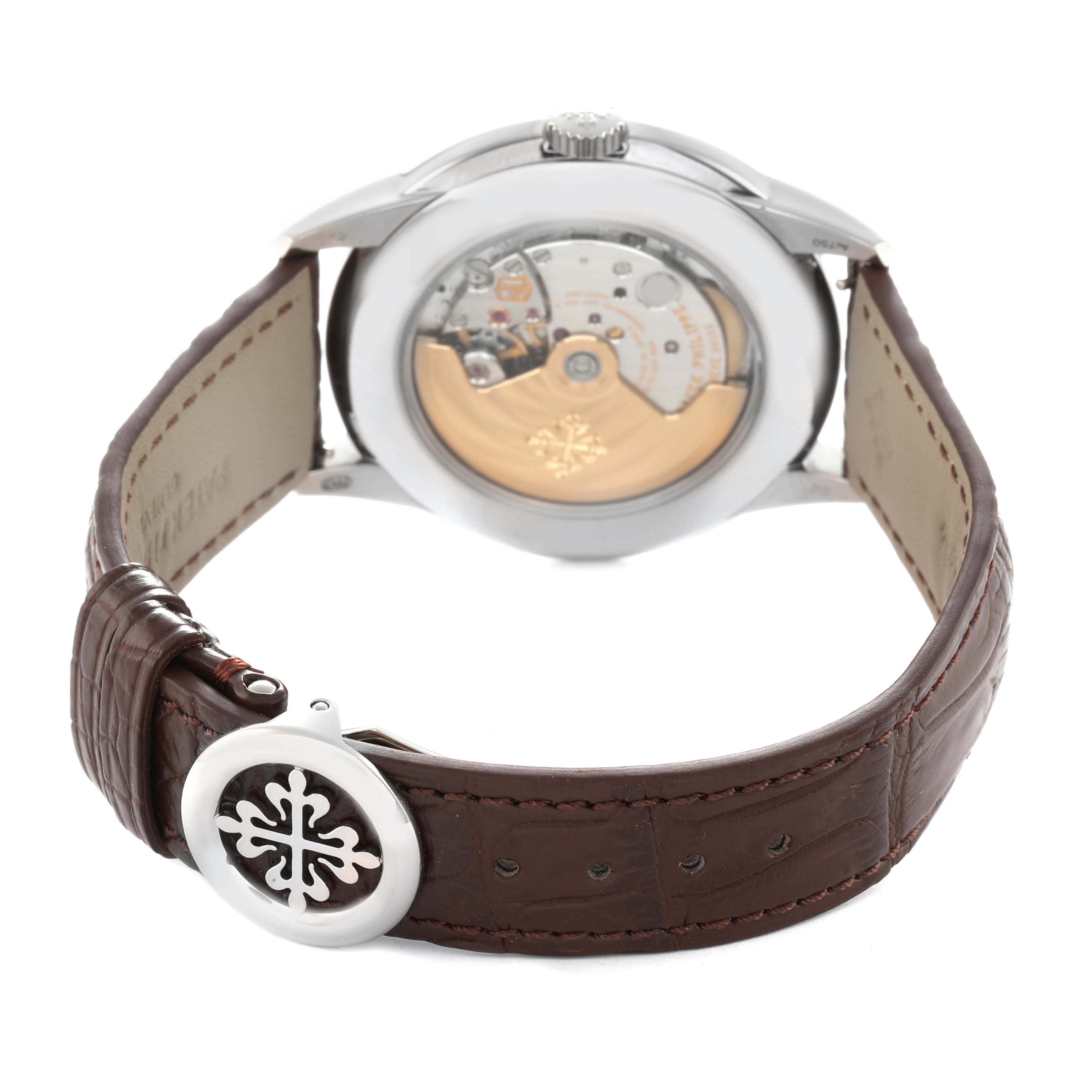 The Patek Philippe Complications 5320G Men's White Gold White Dial watch is shown from the back, highlighting the movement and leather strap with logo clasp.