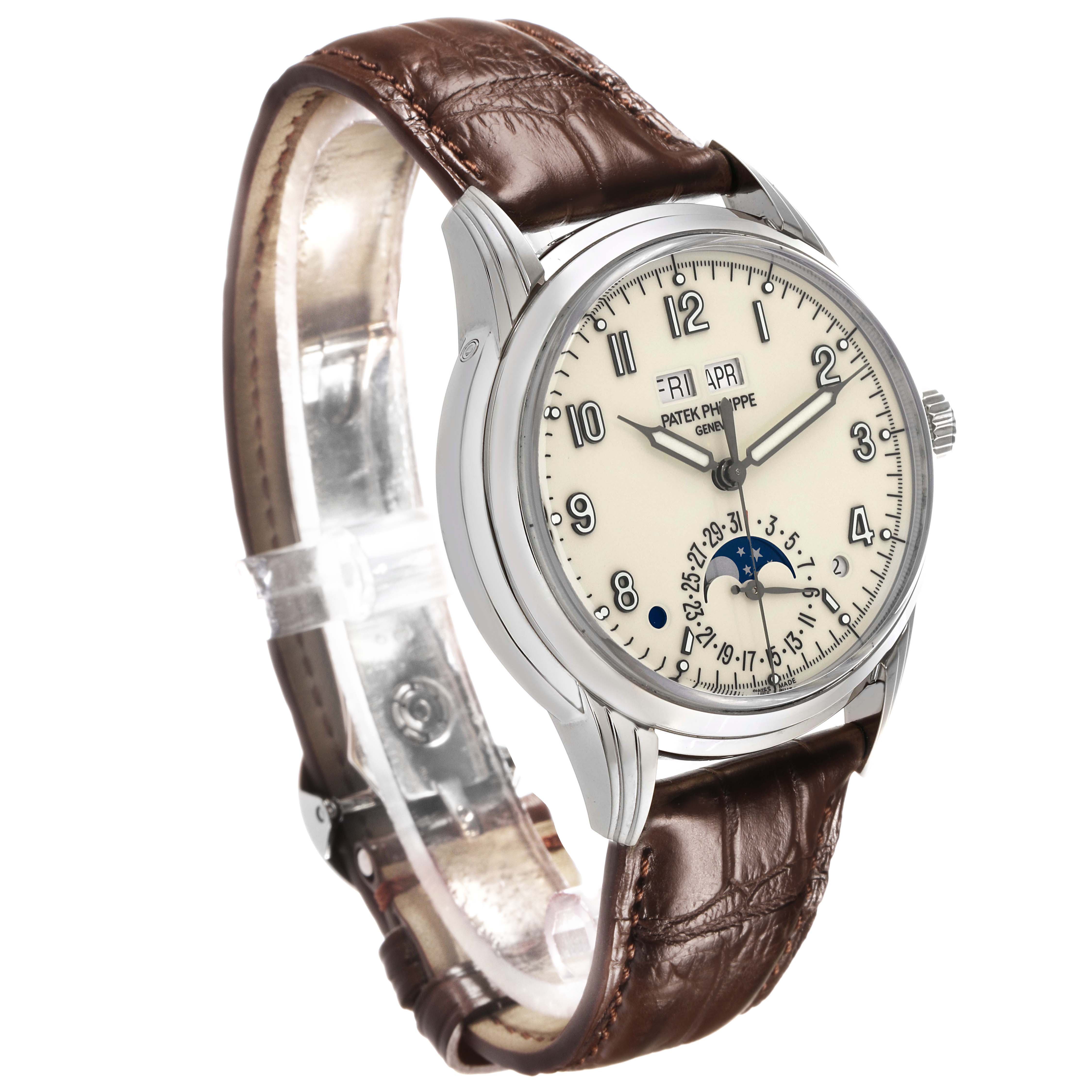 The Patek Philippe Complications 5320G Men's White Gold White Dial model is shown at a three-quarter angle, displaying its face, bezel, crown, and leather strap.