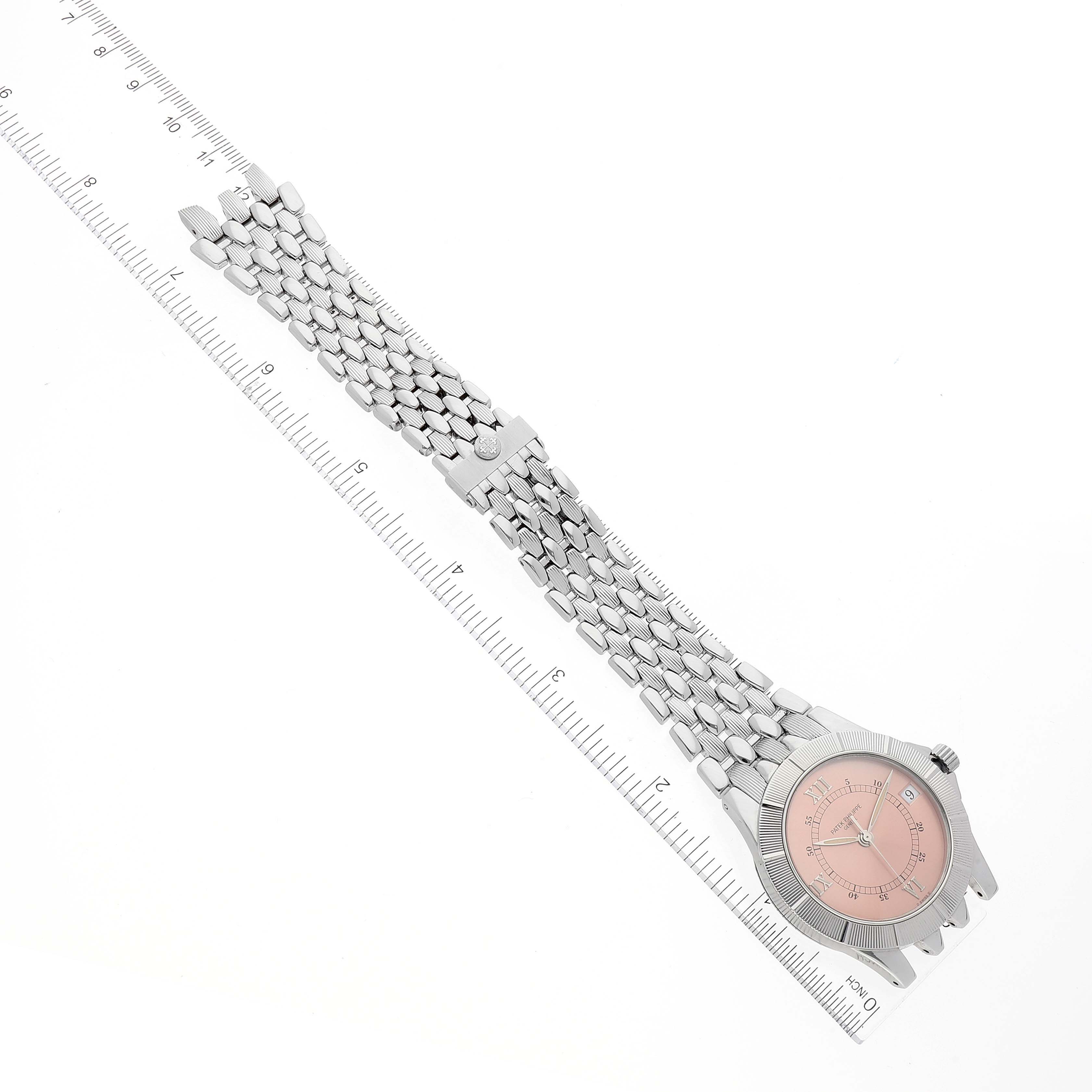 The image shows a Patek Philippe Neptune 5080/001 Men's Stainless Steel Pink Dial 5080/001 Men's Stainless Steel Pink Dial watch from a top-down angle, displaying the entire face, bracelet, and clasp alongside a ruler.
