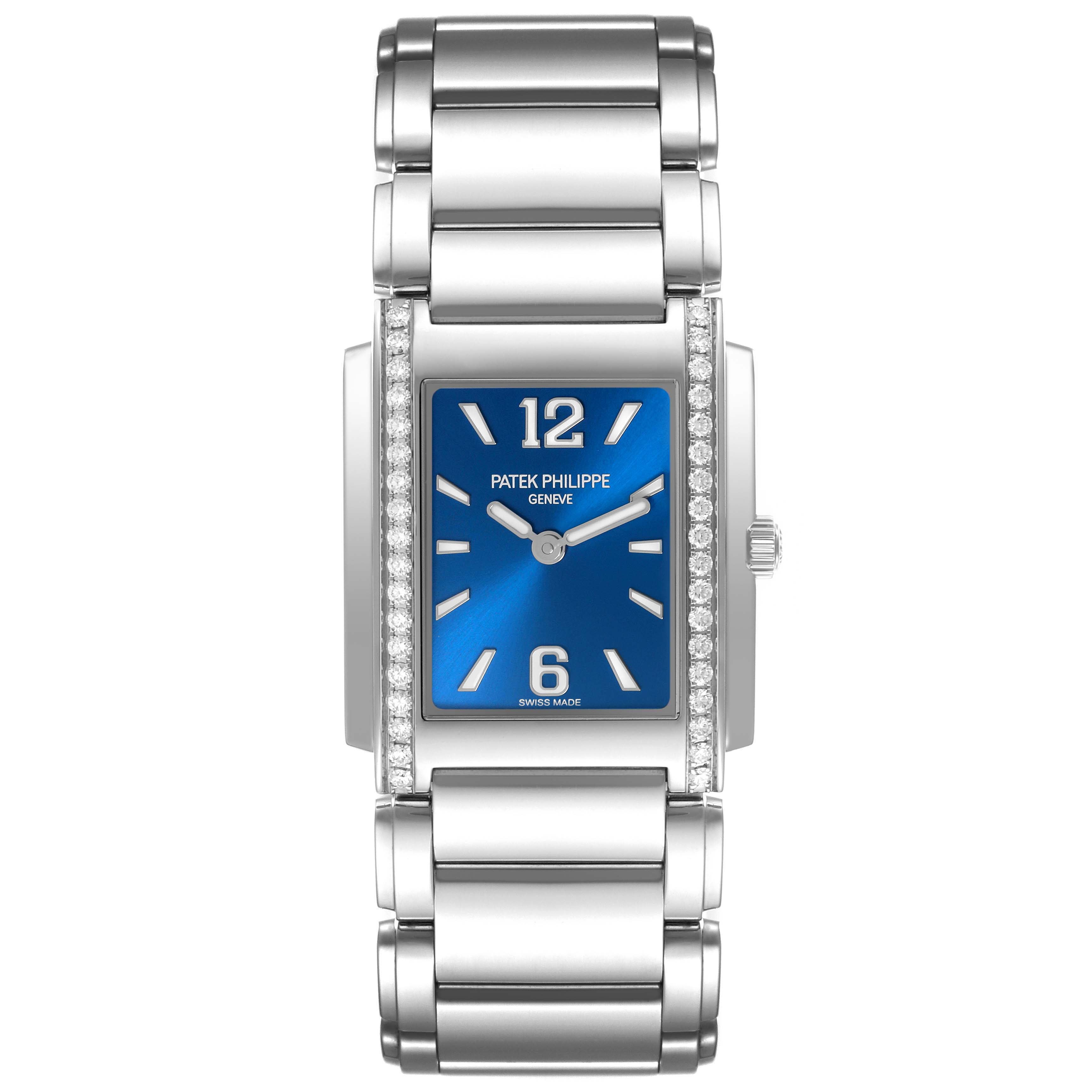 The Patek Philippe Twenty-4 4910/1200A-001 Women's Stainless Steel Blue Dial 4910/1200A-001 Women's Stainless Steel Blue Dial watch is shown from a front angle, displaying its blue dial, diamond-set bezel, and metallic bracelet.