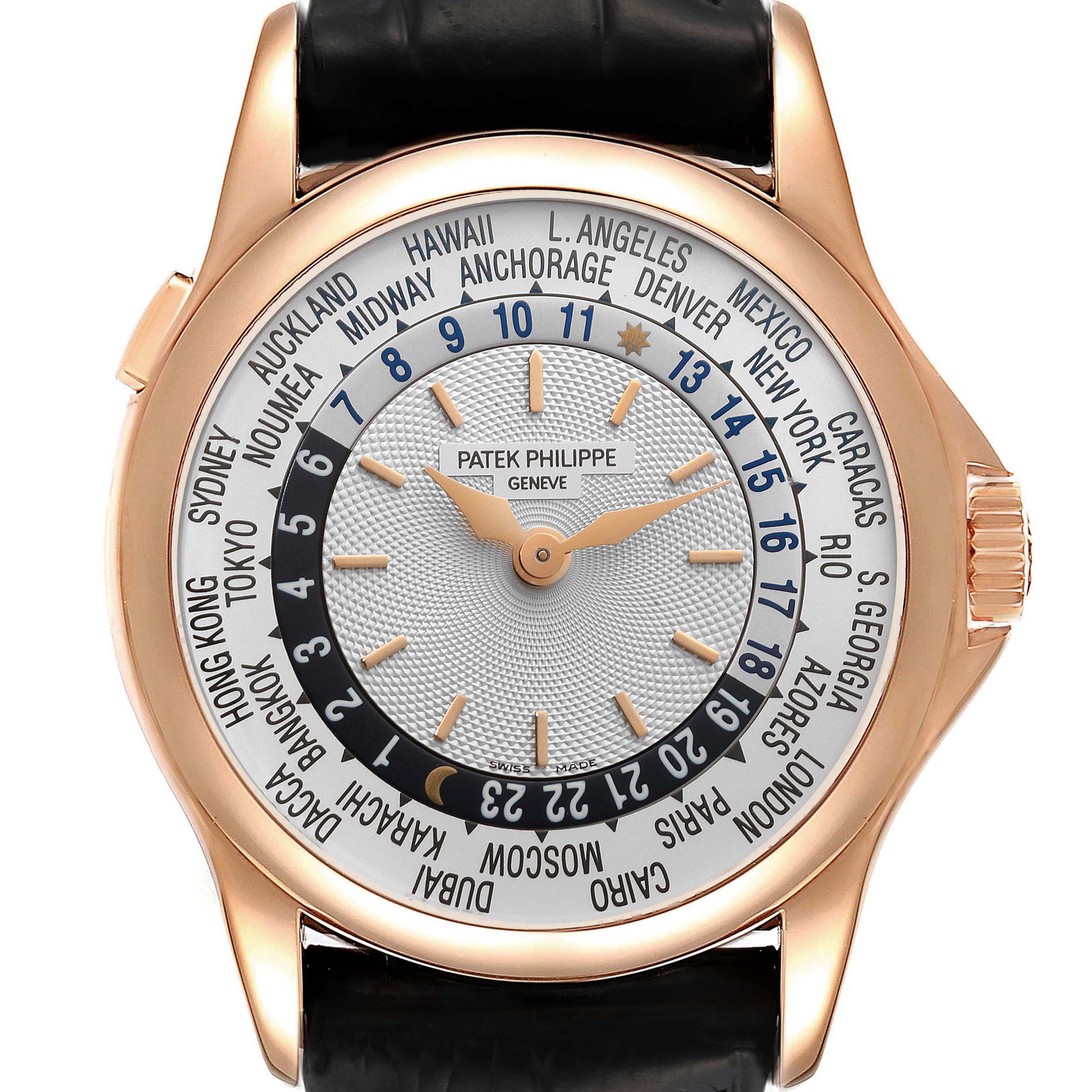 The image shows the face and crown of a Patek Philippe Complications 5110R Men's Yellow Gold Silver Dial 5110R Men's Yellow Gold Silver Dial watch, featuring a rose gold case and world time dial.