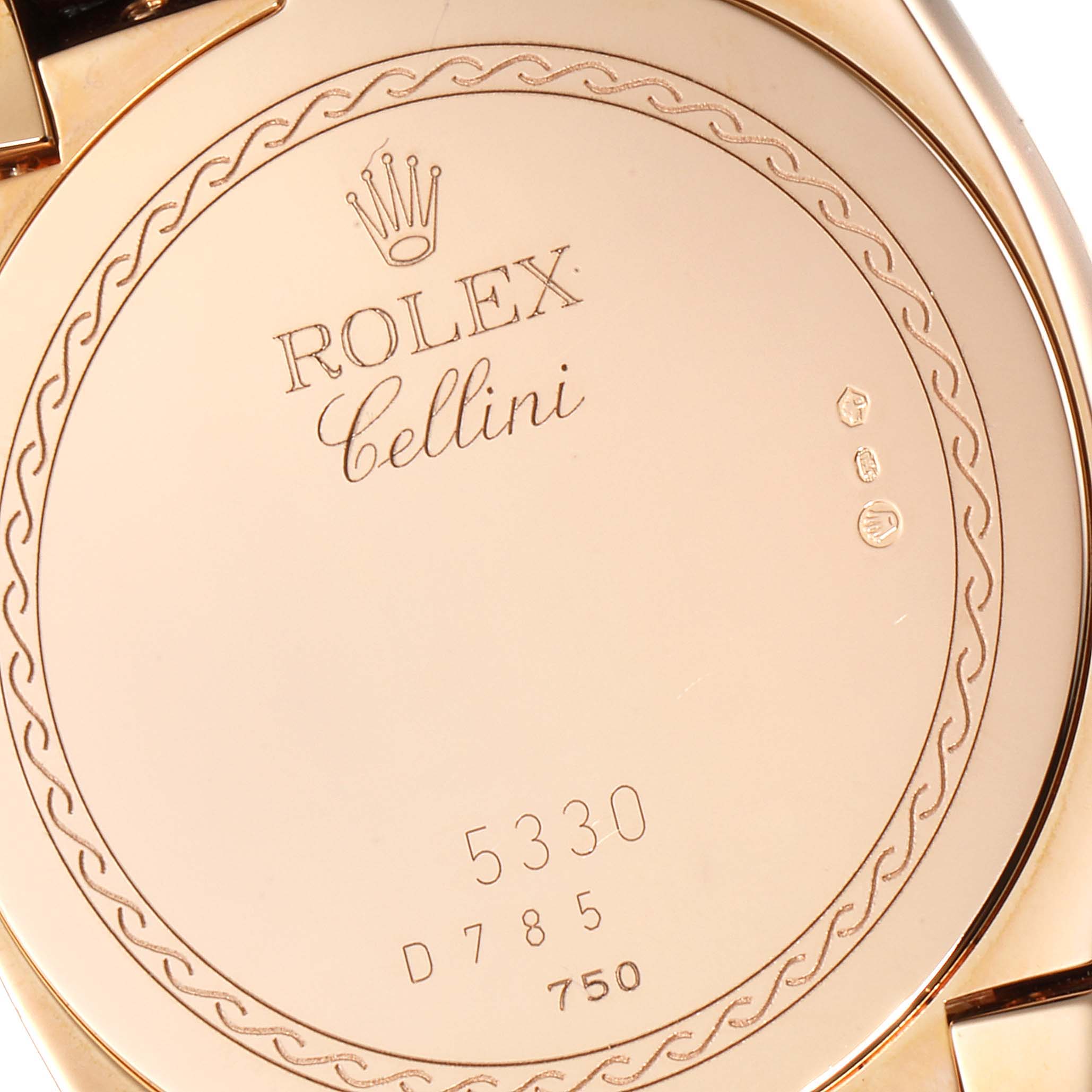 The image shows the back of a Rolex Cellini 5330 Men's Rose Gold White Dial 5330 Men's Rose Gold White Dial watch, highlighting its engraved branding and design details.