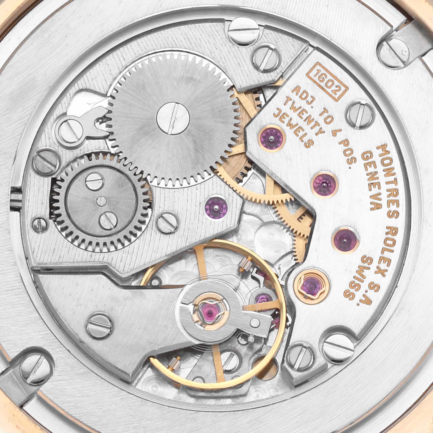 The image shows the Rolex Cellini 5116 Men's Yellow Gold Champagne Dial 5116 Men's Yellow Gold Champagne Dial movement from the back, highlighting gears, jewels, and engravings.
