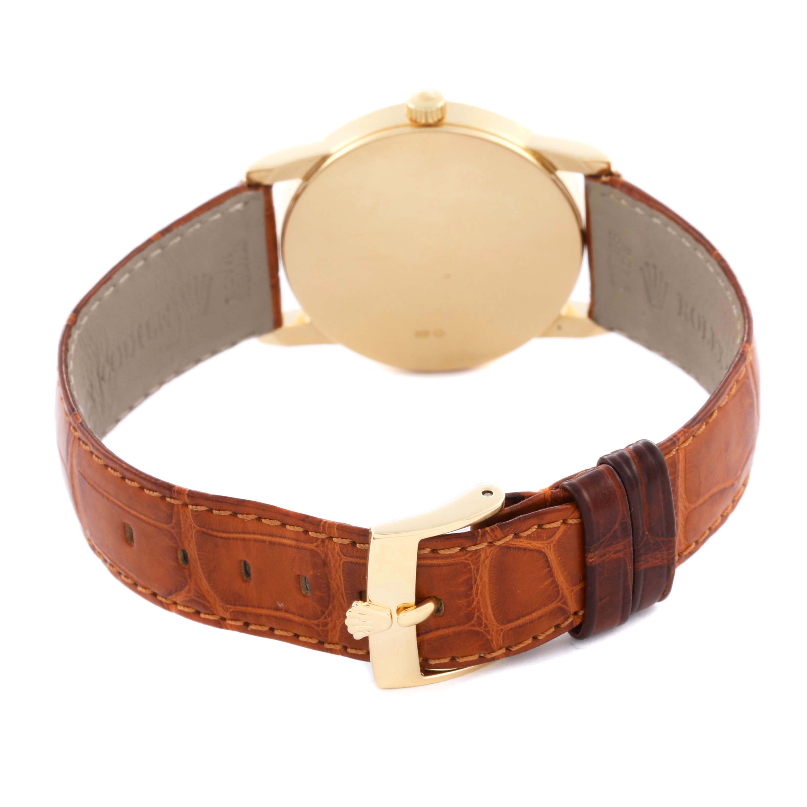 The Rolex Cellini 5116 Men's Yellow Gold Champagne Dial 5116 Men's Yellow Gold Champagne Dial watch is shown from the back, highlighting its gold case, crown, and brown leather strap with a buckle.