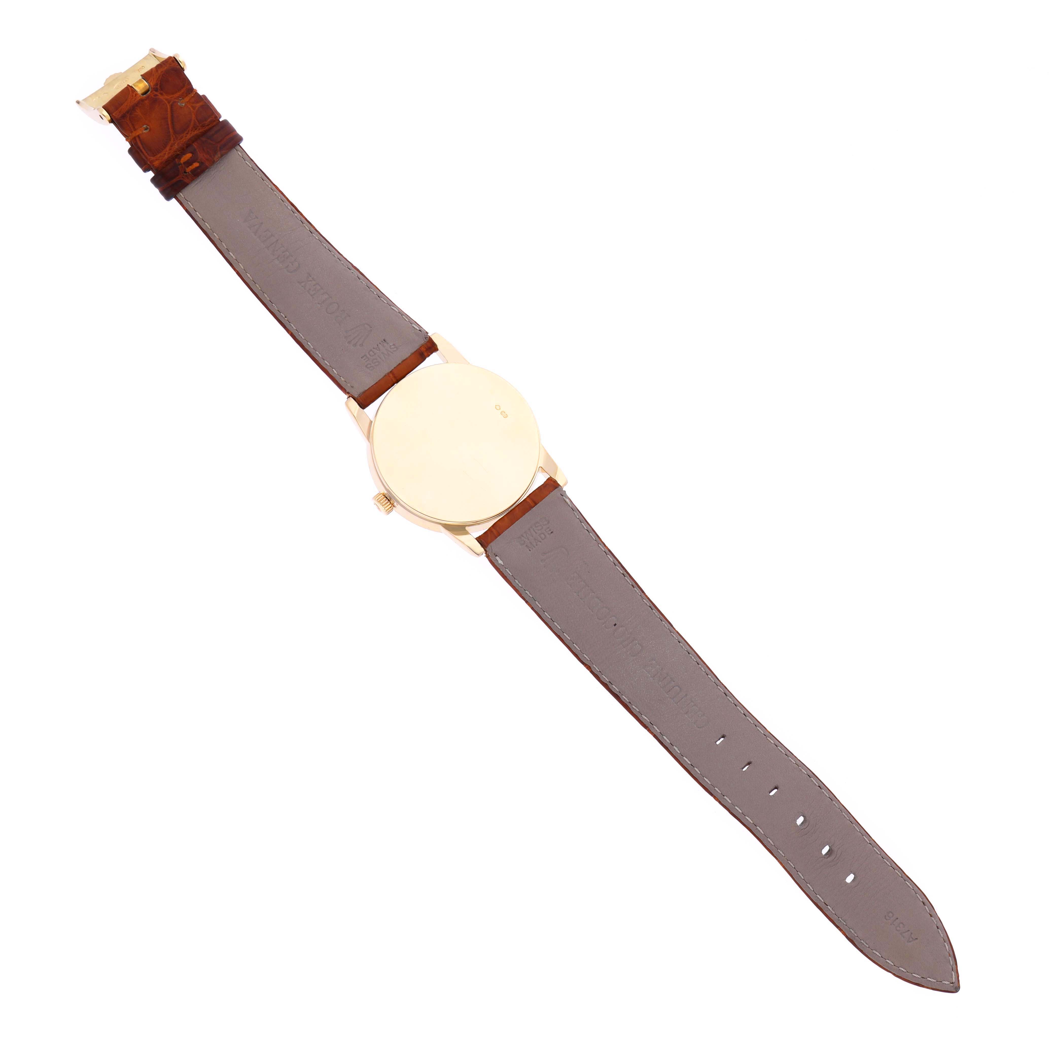 The image shows the back of the Rolex Cellini 5116 Men's Yellow Gold Champagne Dial 5116 Men's Yellow Gold Champagne Dial watch, including the leather strap and gold case, laid flat.