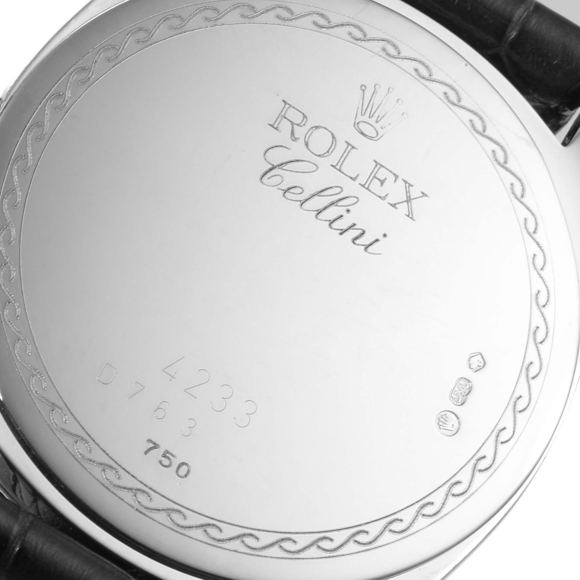 The image shows the back case of a Rolex Cellini 4233 Men
s White Gold Black Dial 4233 Men
s White Gold Black Dial model watch with engraved branding and serial numbers.