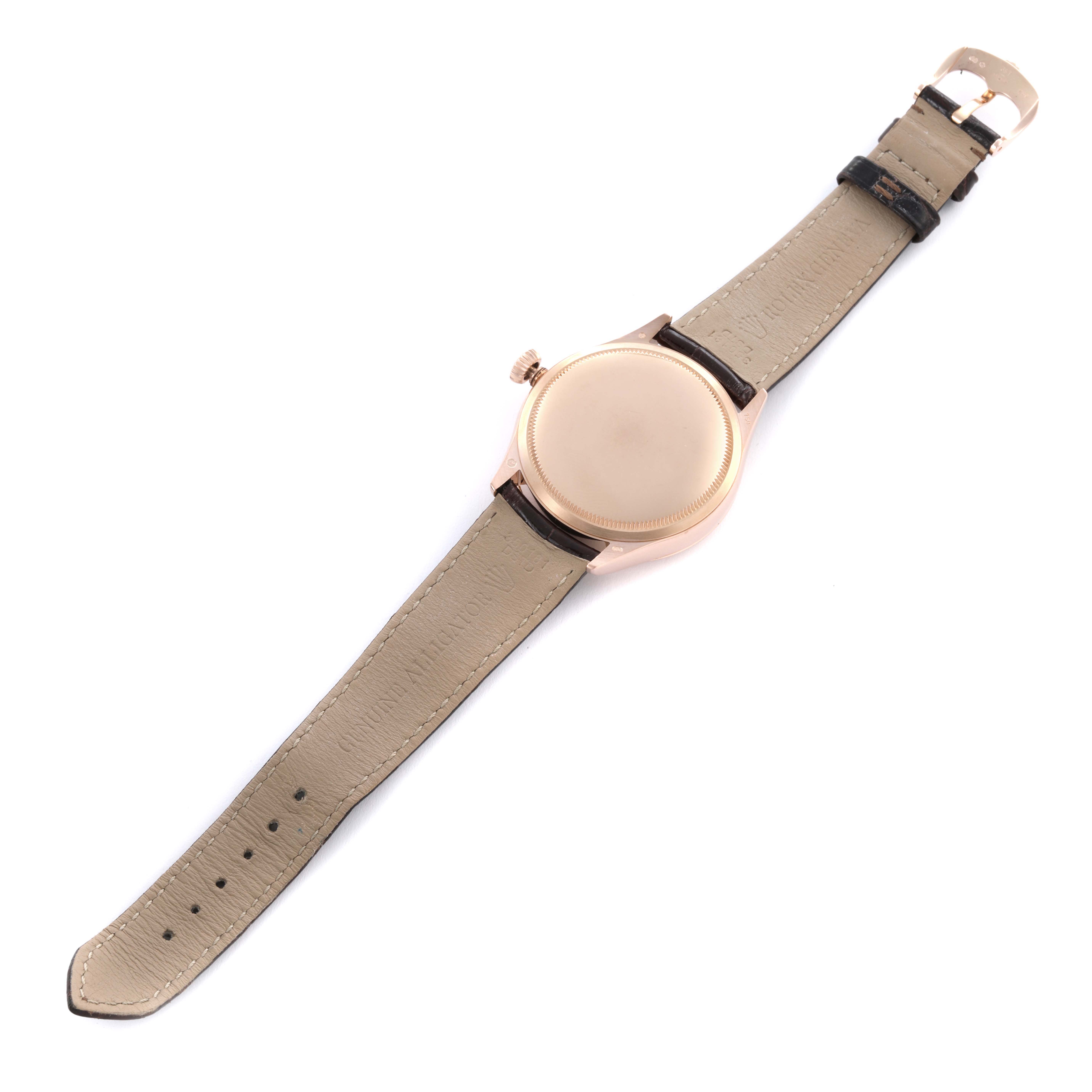 The Rolex Cellini 50525 Men's Rose Gold Silver Dial 50525 Men's Rose Gold Silver Dial watch is shown from the back, highlighting the leather strap and crown, but not the dial.