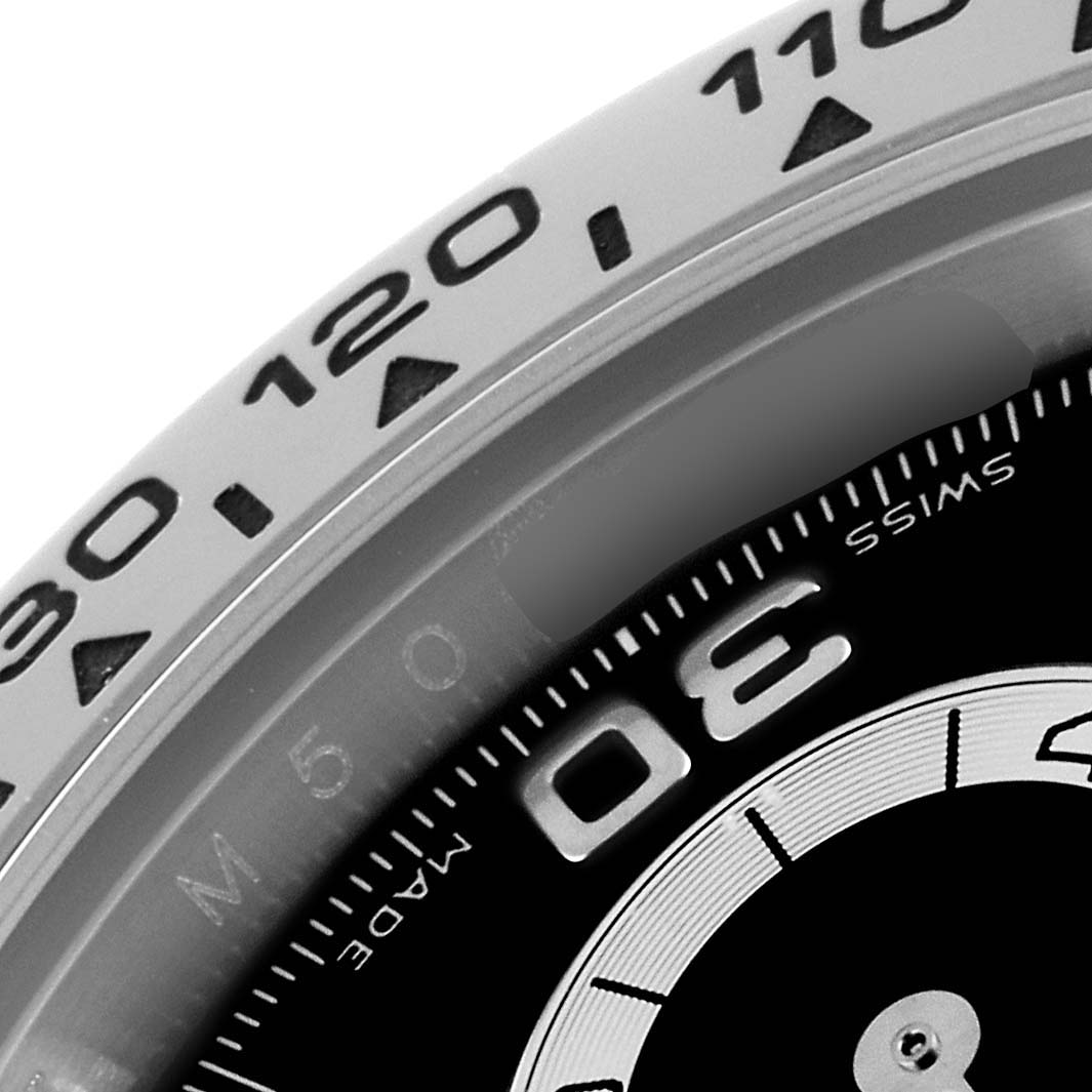 This close-up image shows the bezel and part of the dial of a Rolex Daytona 116509 Men's White Gold Black Dial 116509 Men's White Gold Black Dial watch.