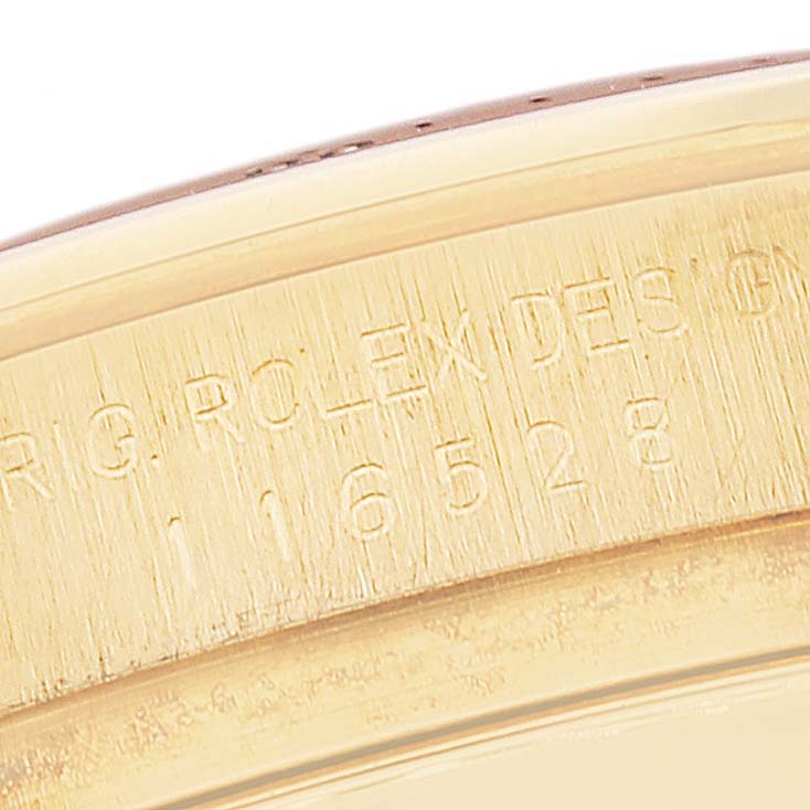 The image shows a close-up view of the side engraving on a Rolex Daytona 116528 Men's Yellow Gold Black Dial 116528 Men's Yellow Gold Black Dial watch, featuring the model number 116528.