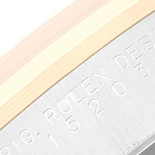 This close-up image shows the inner bezel of a Rolex Date 15203 Men's Steel and Gold (two tone) White Dial 15203 Men's Steel and Gold (two tone) White Dial watch with engraved lettering and part of the case.