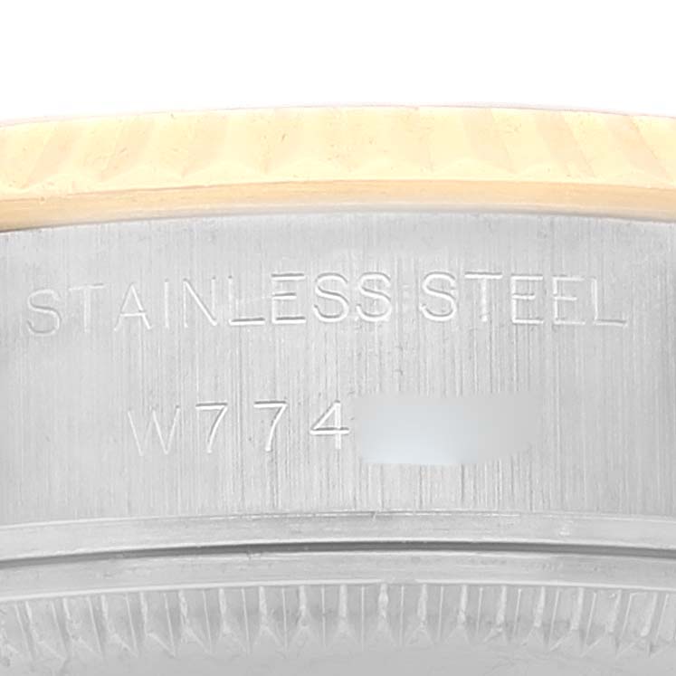 The image shows a close-up of the serial number and "STAINLESS STEEL" engraving on a Rolex Datejust 69173 Women's Steel and Gold (two tone) Champagne Dial 69173 Women's Steel and Gold (two tone) Champagne Dial watch case.