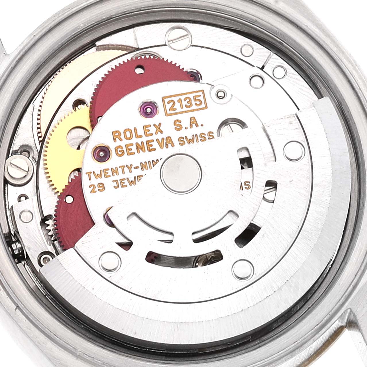 The image shows the internal mechanism of a Rolex Datejust 69173 Women's Steel and Gold (two tone) Champagne Dial 69173 Women's Steel and Gold (two tone) Champagne Dial watch, specifically the movement with visible gears and engraved details.