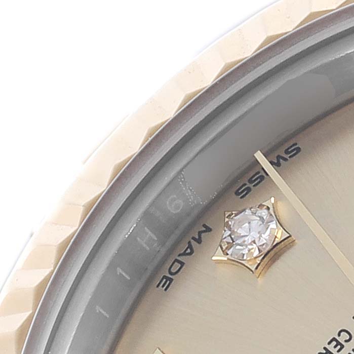 The image shows a close-up of the Rolex Datejust 279173 Women's Steel and Gold (two tone) Champagne Dial 279173 Women's Steel and Gold (two tone) Champagne Dial watch dial, featuring part of the bezel and a diamond hour marker.