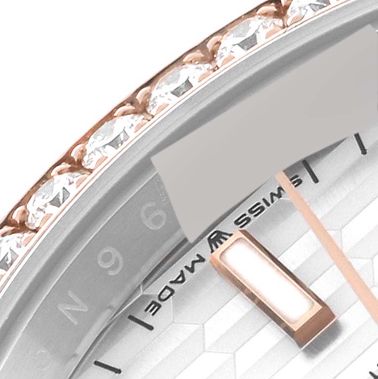 This close-up shows the bezel adorned with diamonds and part of the dial, minute markers, and a single index of a Rolex Datejust 126281 Men's Steel and Gold (two tone) Silver Dial 126281 Men's Steel and Gold (two tone) Silver Dial watch.