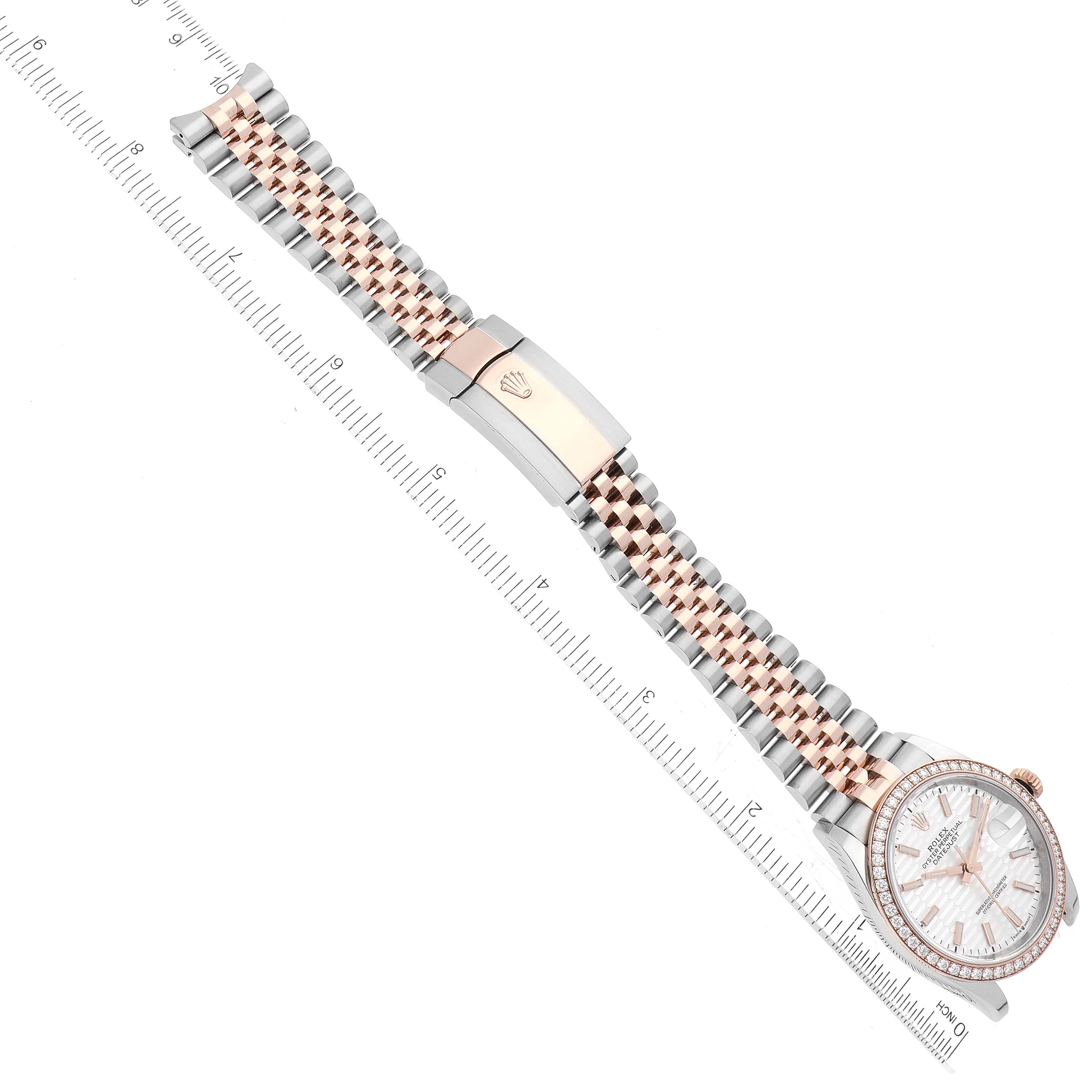 This Rolex Datejust 126281 Men's Steel and Gold (two tone) Silver Dial 126281 Men's Steel and Gold (two tone) Silver Dial watch is shown from a top-down angle, displaying the entire face, bracelet, clasp, and a measuring scale.