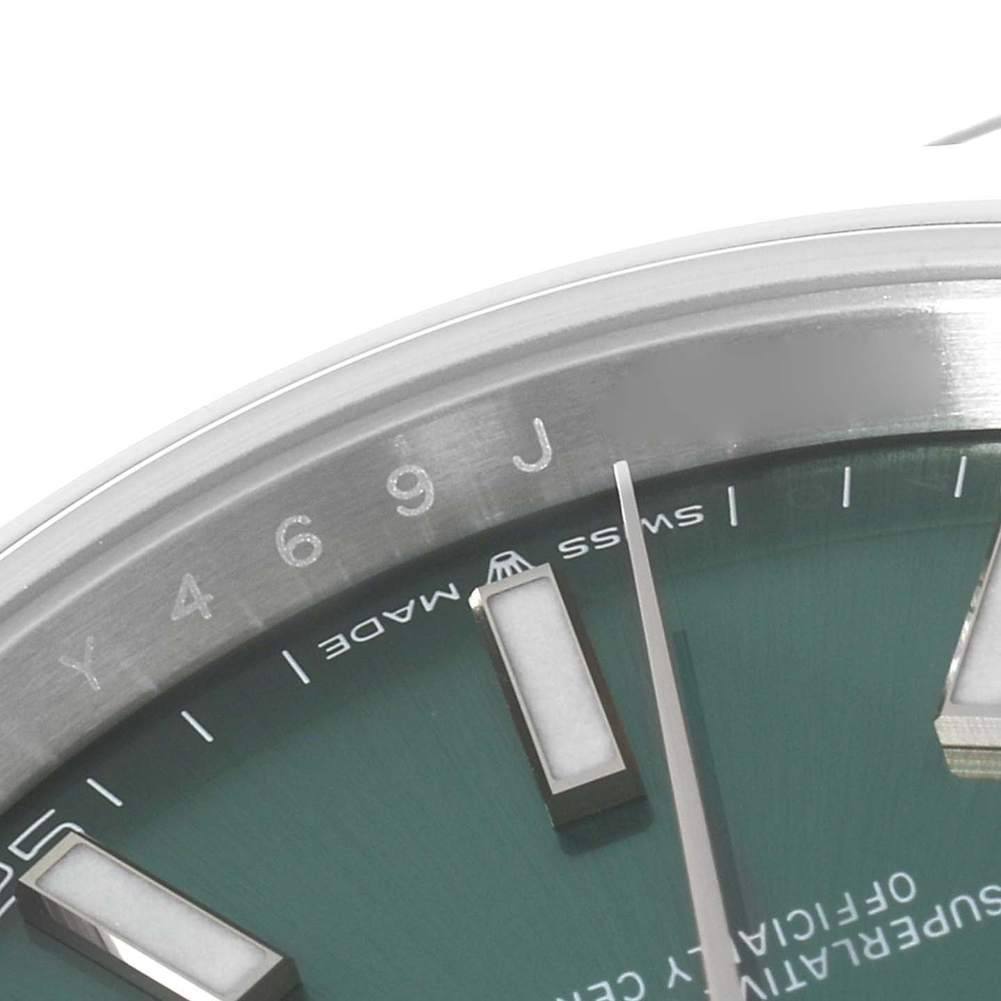 The image shows a close-up of the Rolex Datejust 41 126300 Men's Stainless Steel Green Dial 126300 Men's Stainless Steel Green Dial watch face, highlighting the hour markers, seconds hand, and part of the bezel.