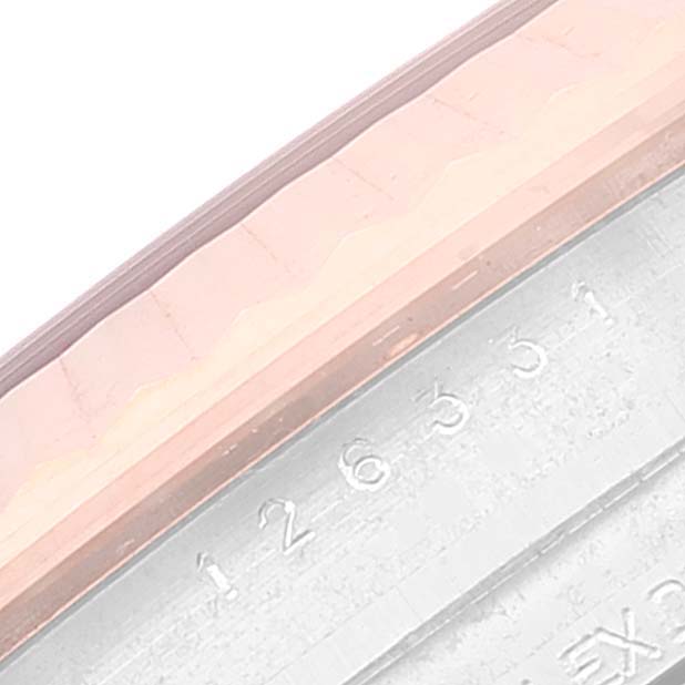 This close-up image shows a partial view of the bezel and the serial number of a Rolex Datejust 41 126331 Men's Steel and Gold (two tone) Brown Dial 126331 Men's Steel and Gold (two tone) Brown Dial watch.