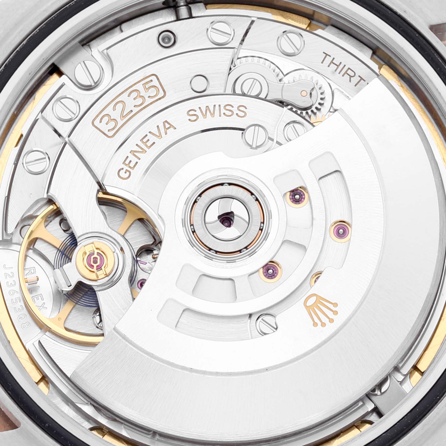 The image shows a close-up of the movement of a Rolex Datejust 41 126331 Men's Steel and Gold (two tone) Brown Dial 126331 Men's Steel and Gold (two tone) Brown Dial watch, highlighting the intricate internal mechanism.
