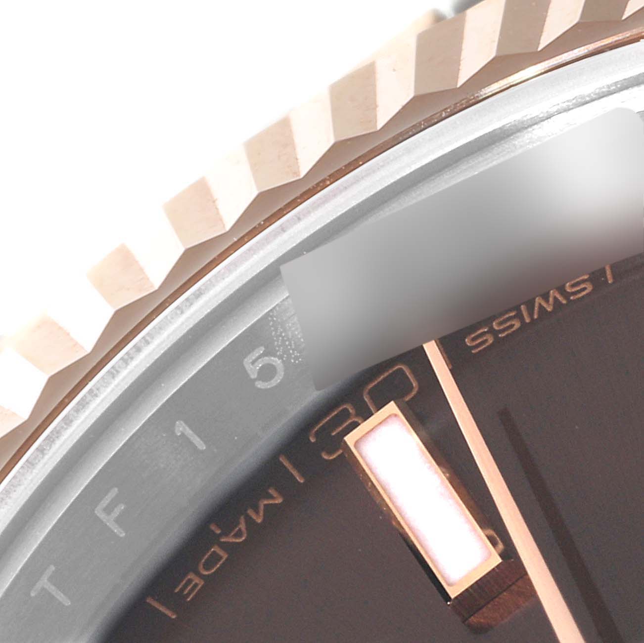 This image shows a close-up of the bezel and part of the dial of a Rolex Datejust 41 126331 Men's Steel and Gold (two tone) Brown Dial 126331 Men's Steel and Gold (two tone) Brown Dial watch.